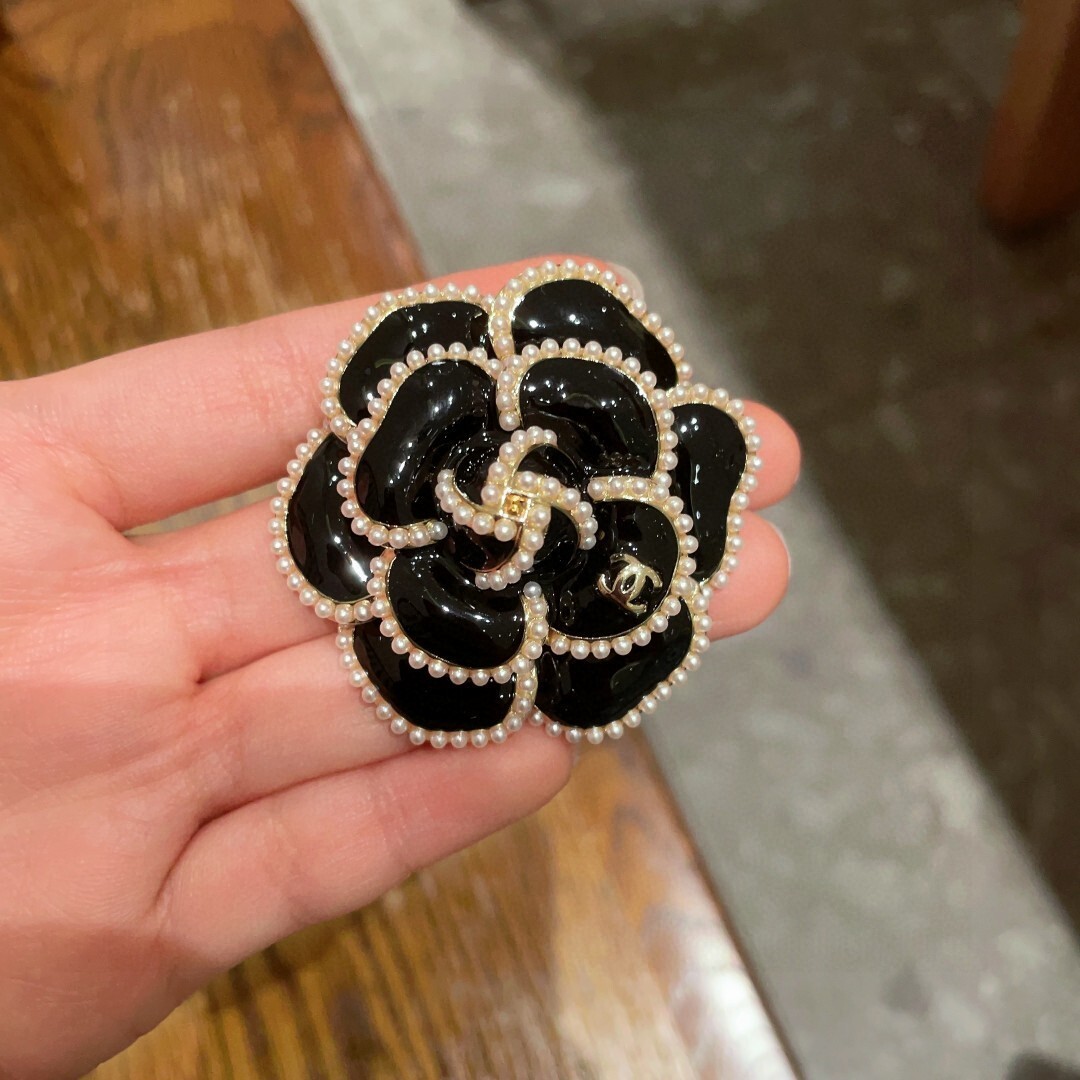 Elegant Black Camellia Flower Brooch with Pearl Trim & Gold Logo