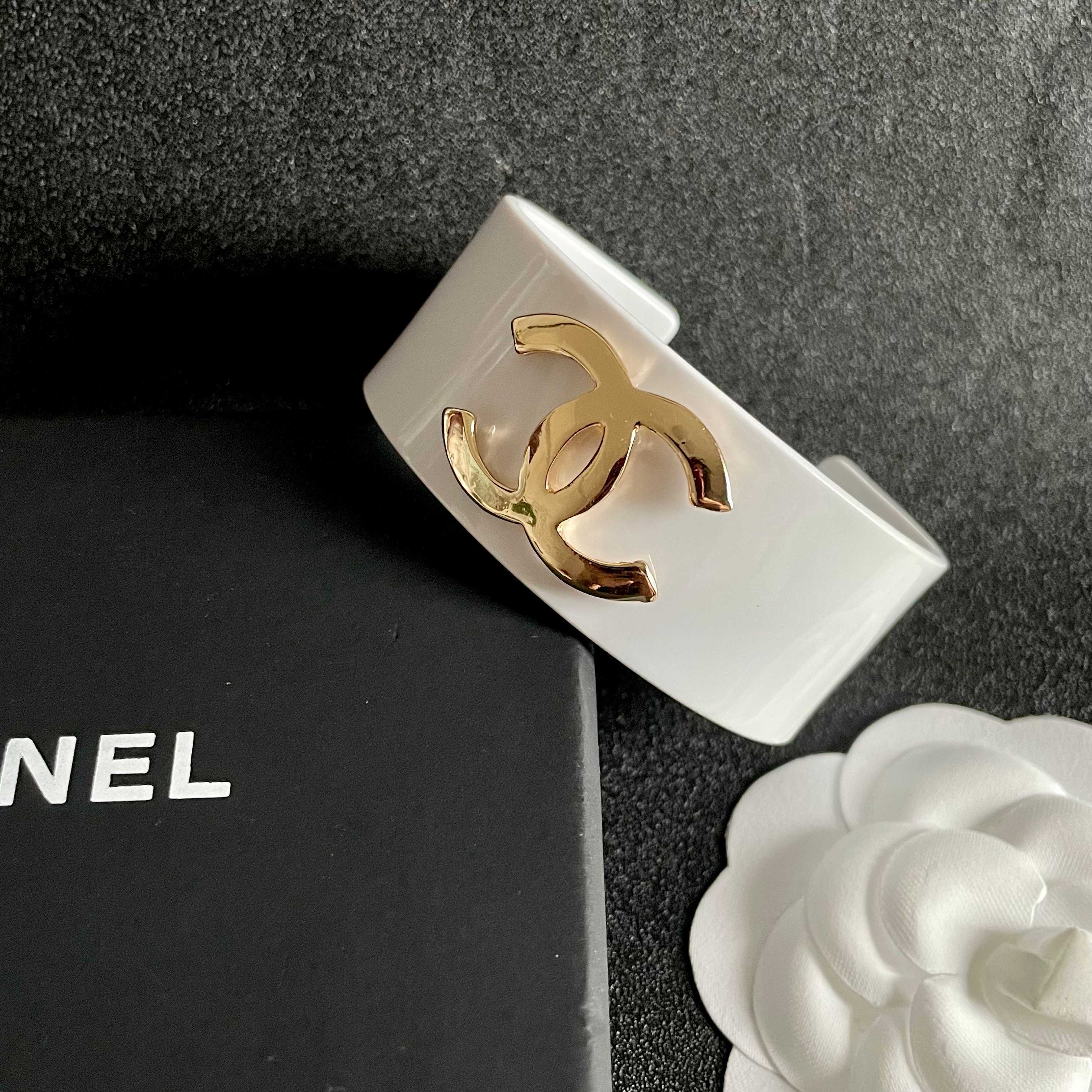 Elegant White Cuff Bracelet with Gold Logo - Chic Luxury Accessory