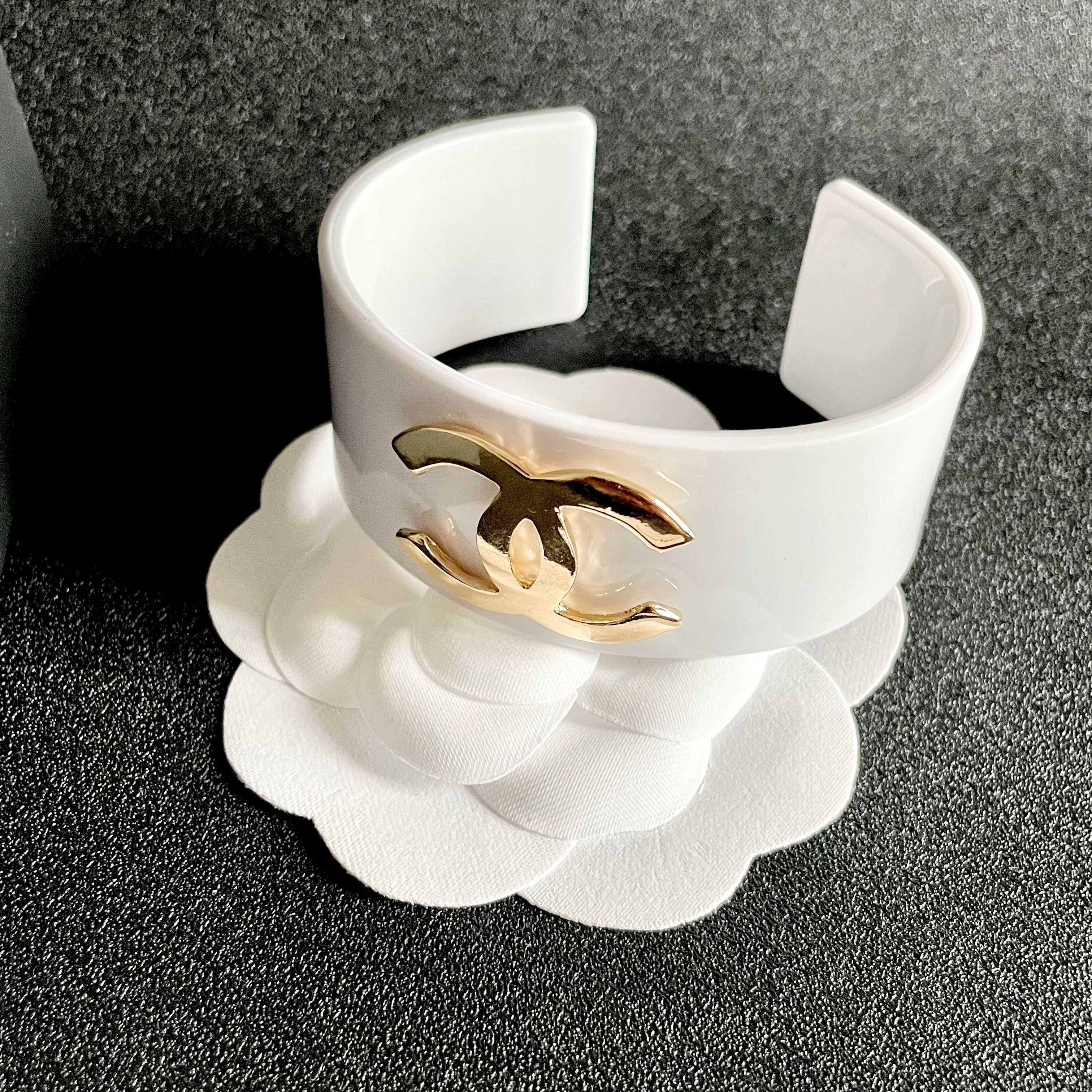 Elegant White Cuff Bracelet with Gold Logo - Chic Luxury Accessory