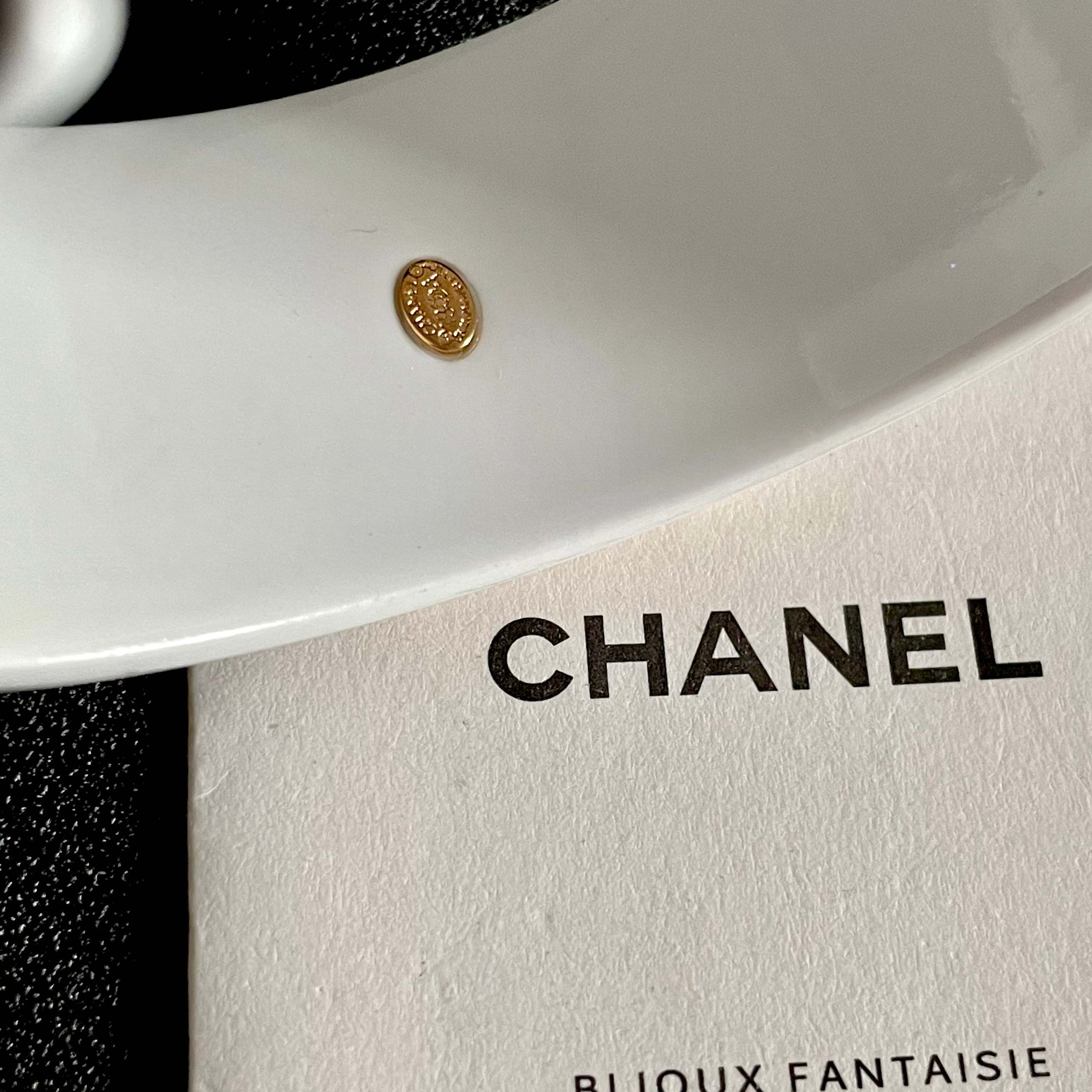 Elegant White Cuff Bracelet with Gold Logo - Chic Luxury Accessory