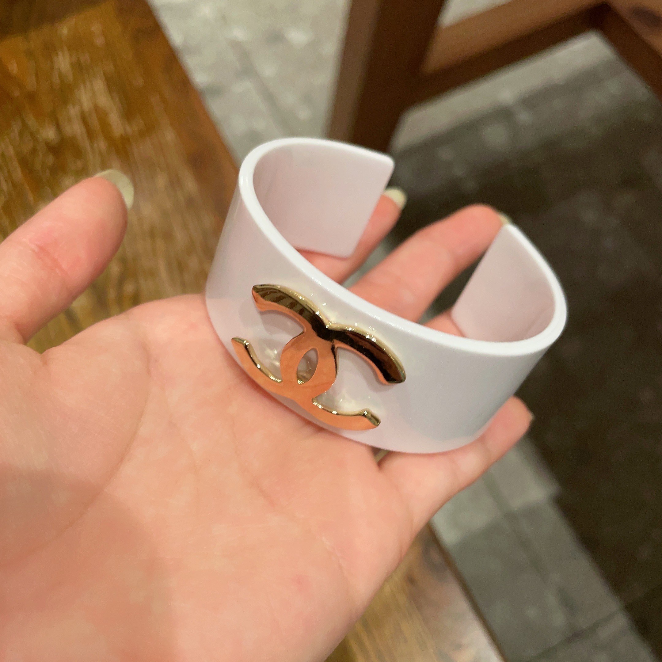 Elegant White Cuff Bracelet with Gold Logo - Chic Luxury Accessory