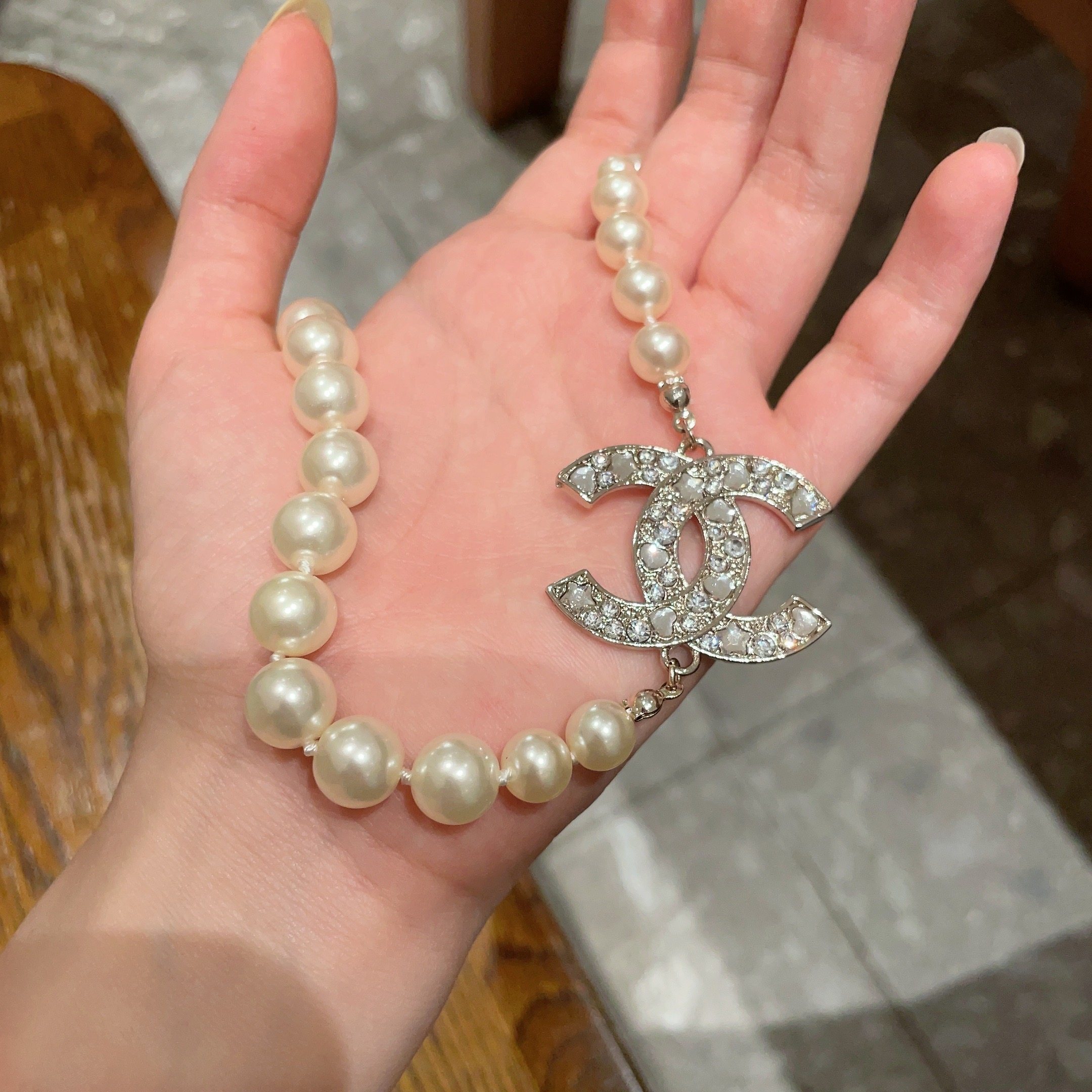 Elegant Pearl Necklace with Sparkling Crystal CC Logo Pendant