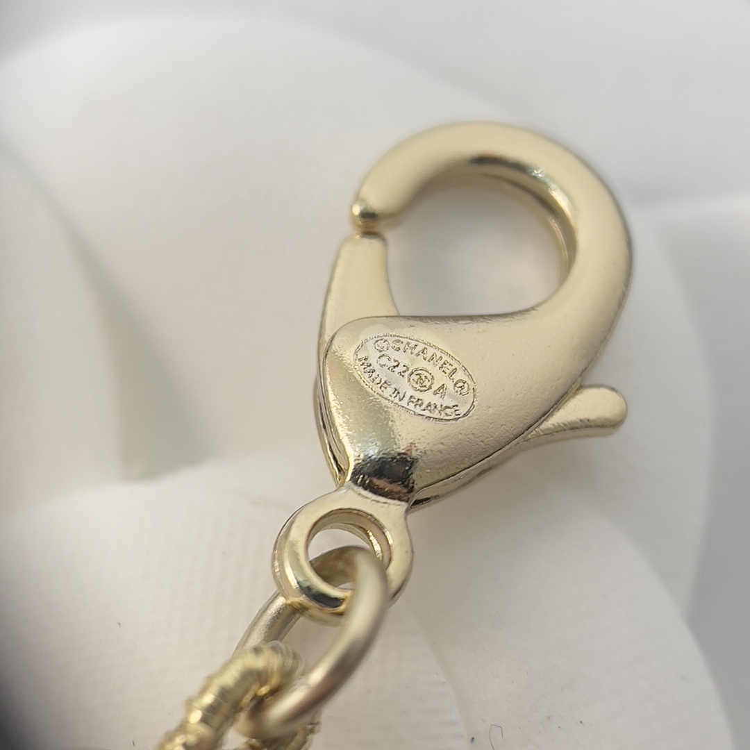 Chanel Elegant Long Pearl Necklace with Embellished CC Logos