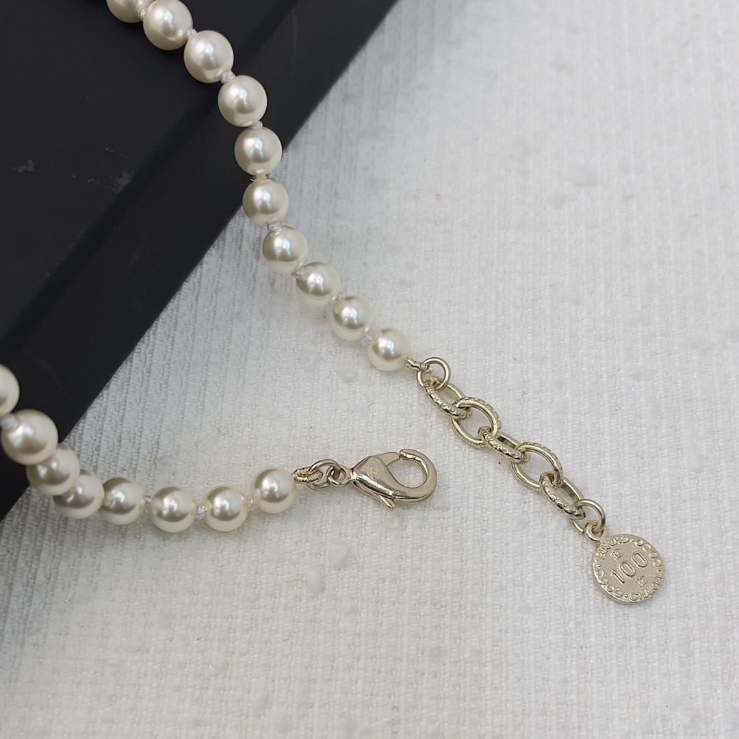 Chanel Elegant Long Pearl Necklace with Embellished CC Logos