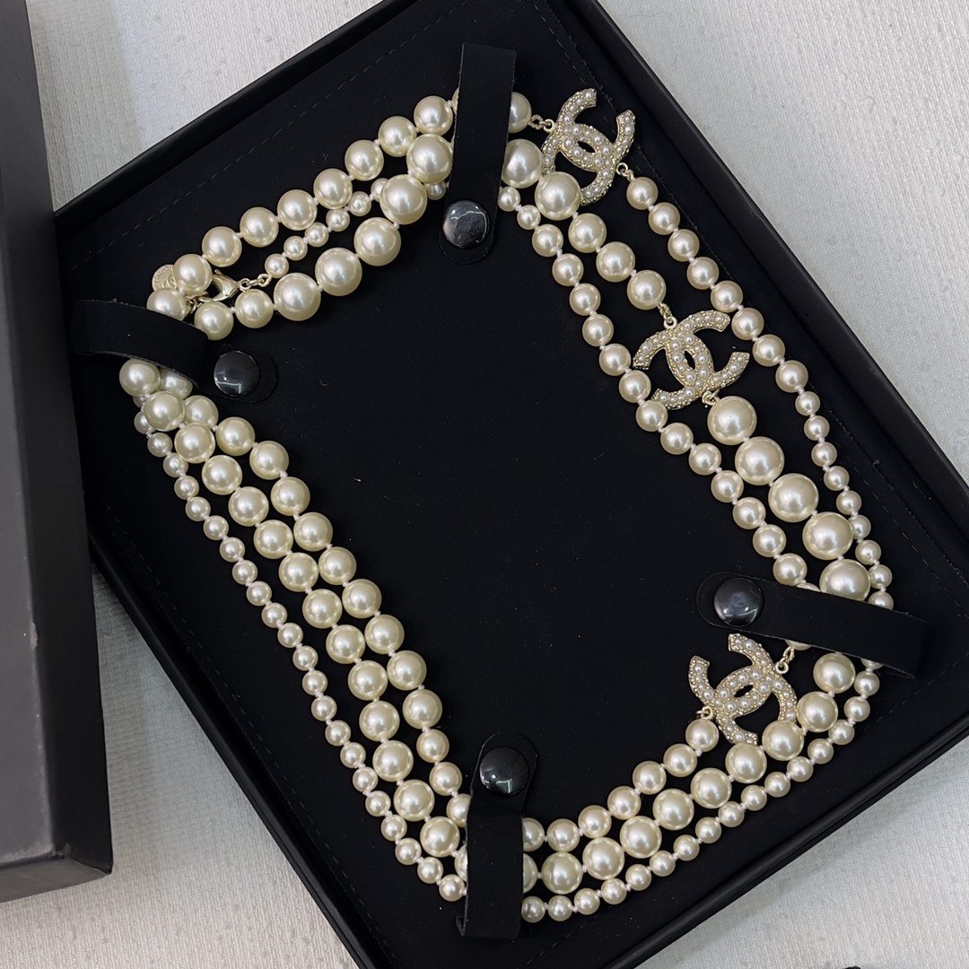 Chanel Elegant Long Pearl Necklace with Embellished CC Logos