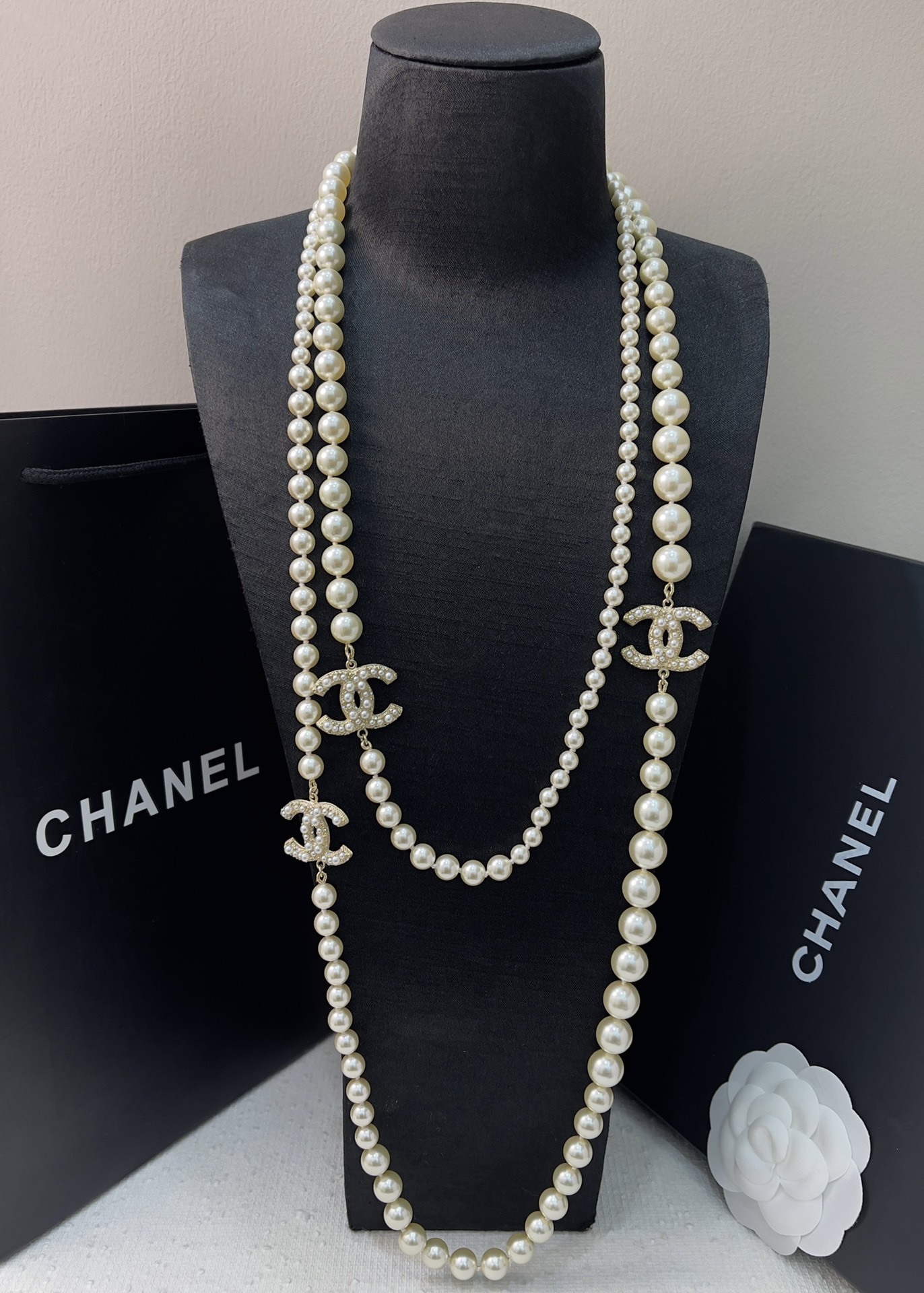 Chanel Elegant Long Pearl Necklace with Embellished CC Logos