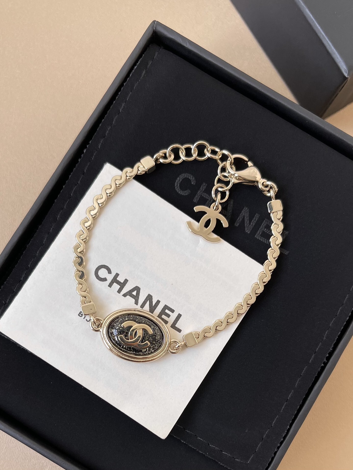 Chanel Gold CC Logo Bracelet with Black Glitter Oval Pendant