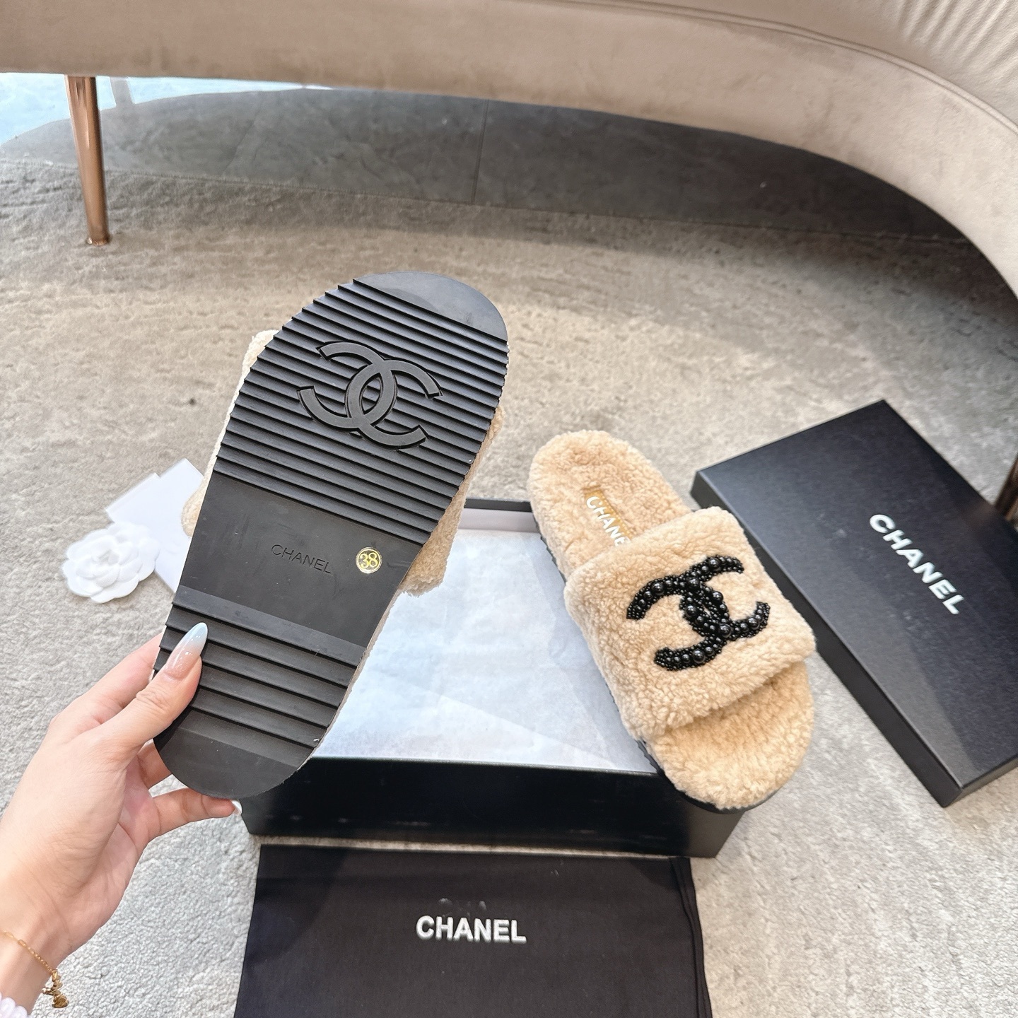 Pair of Chanel beige fuzzy shearling slide sandals with black beaded interlocking CC logo in original packaging. - Hình 9