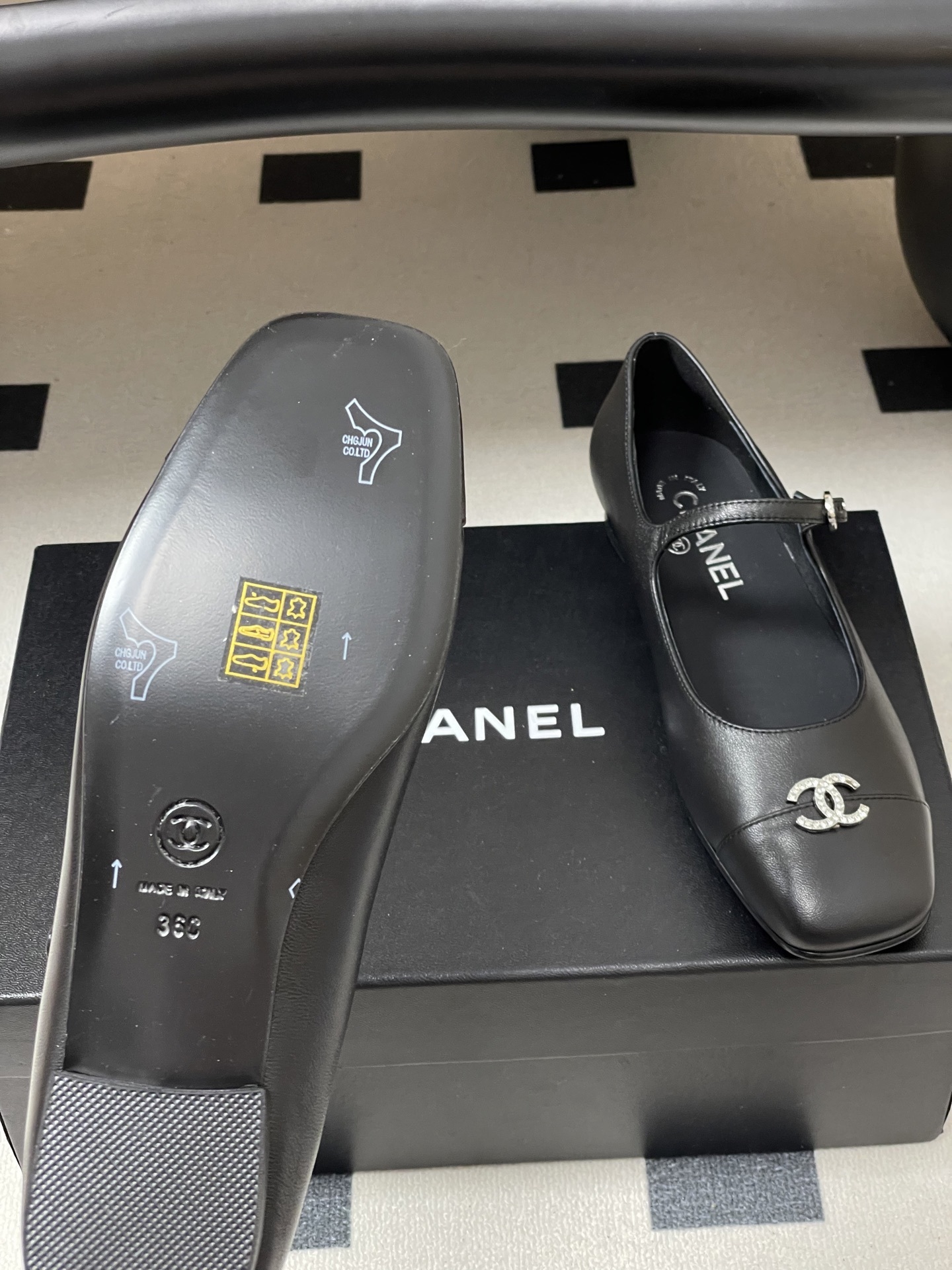 A pair of black leather Chanel Mary Jane flats featuring crystal-embellished CC logos on the toes and crystal buckles on the straps. - Hình 8