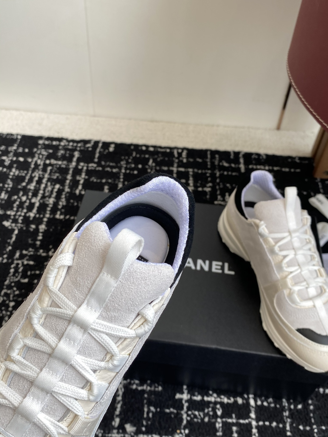 Pair of Chanel white and black suede mesh sneakers with CC logo on a black box - Hình 8