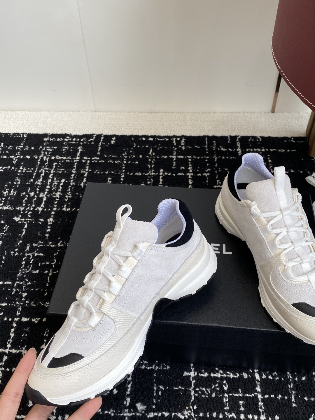 Pair of Chanel white and black suede mesh sneakers with CC logo on a black box - Hình 7