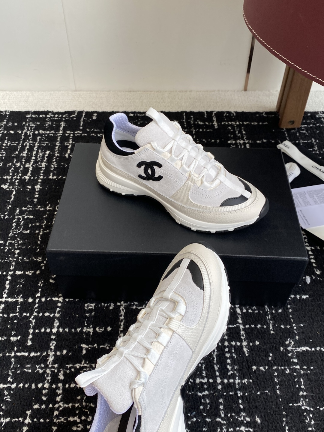 Pair of Chanel white and black suede mesh sneakers with CC logo on a black box - Hình 6