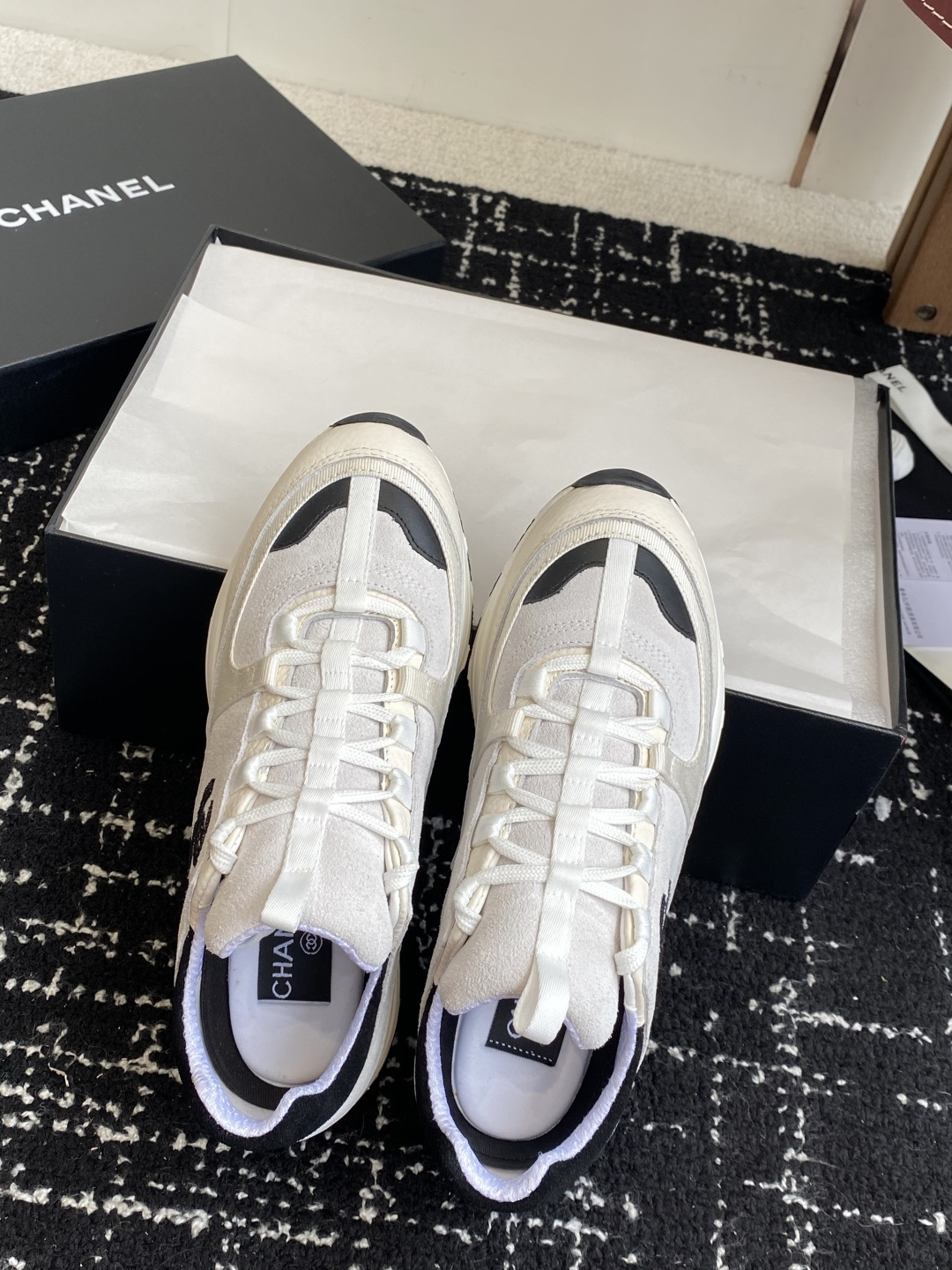 Pair of Chanel white and black suede mesh sneakers with CC logo on a black box - Hình 5