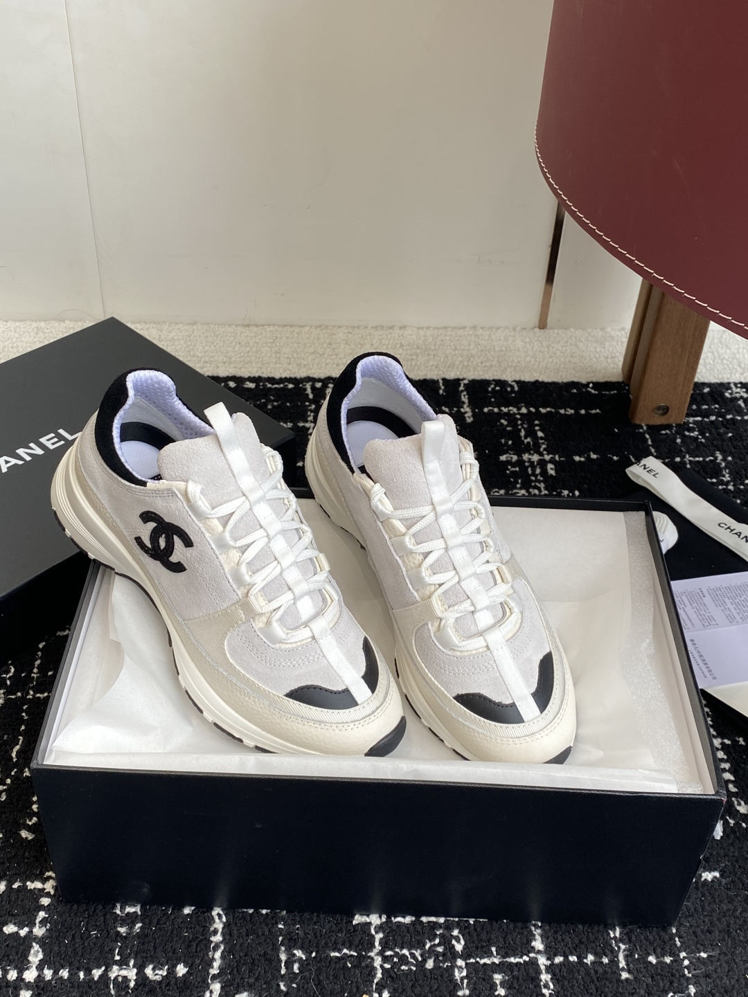 Pair of Chanel white and black suede mesh sneakers with CC logo on a black box - Hình 4