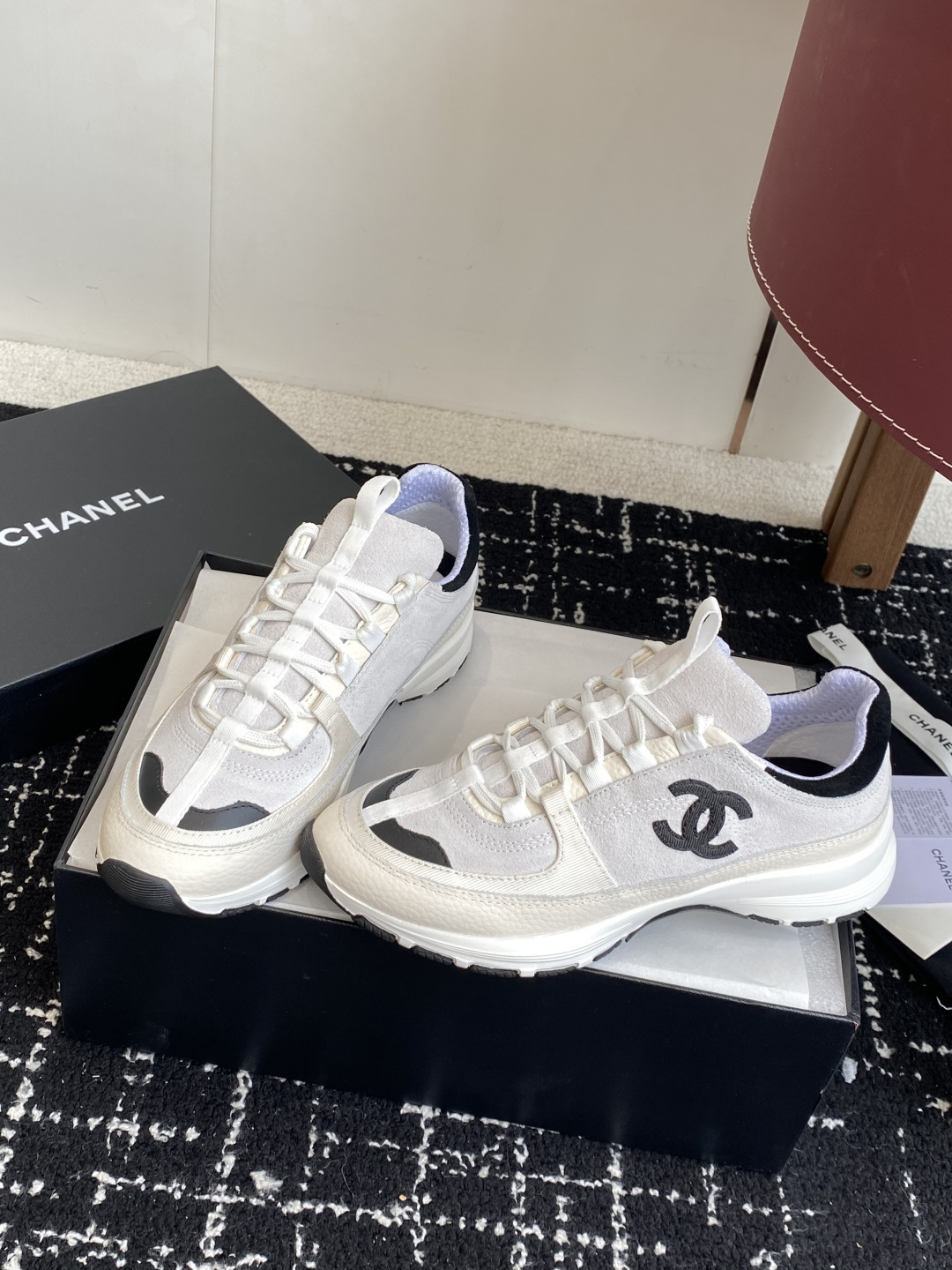 Pair of Chanel white and black suede mesh sneakers with CC logo on a black box - Hình 3