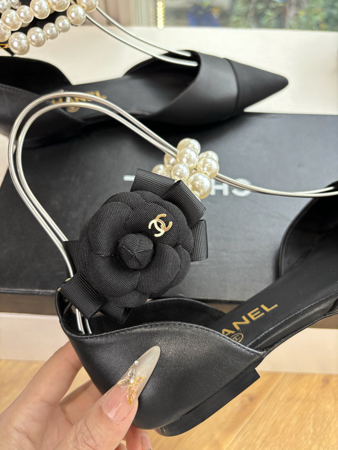 Pair of Chanel black leather pointed-toe flats with double-row pearl ankle straps and black camellia flower detail. - Hình 8