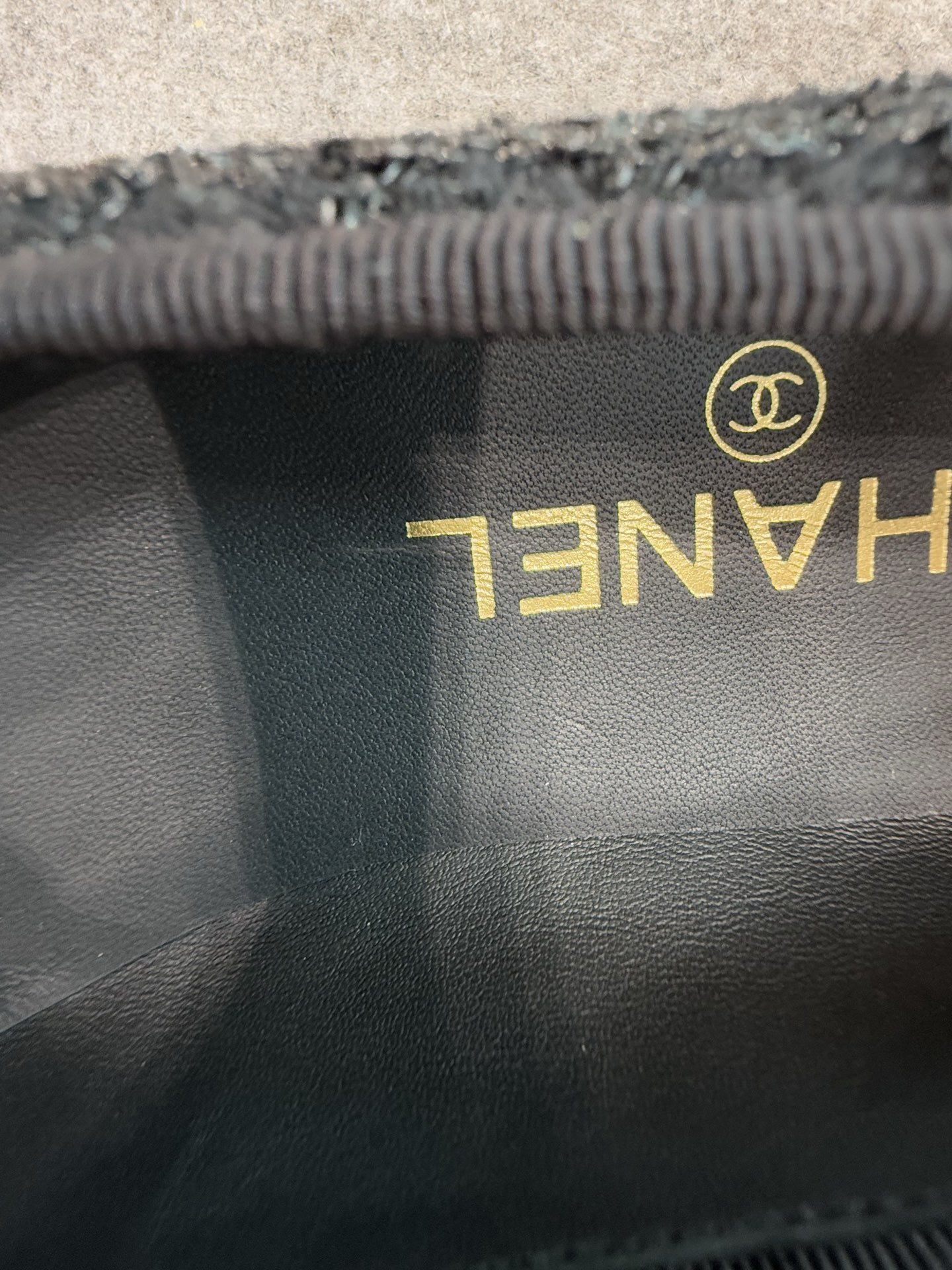 Top view of Chanel black tweed ballet flats with sequins and CC logo toe cap on a luxury display - Hình 9