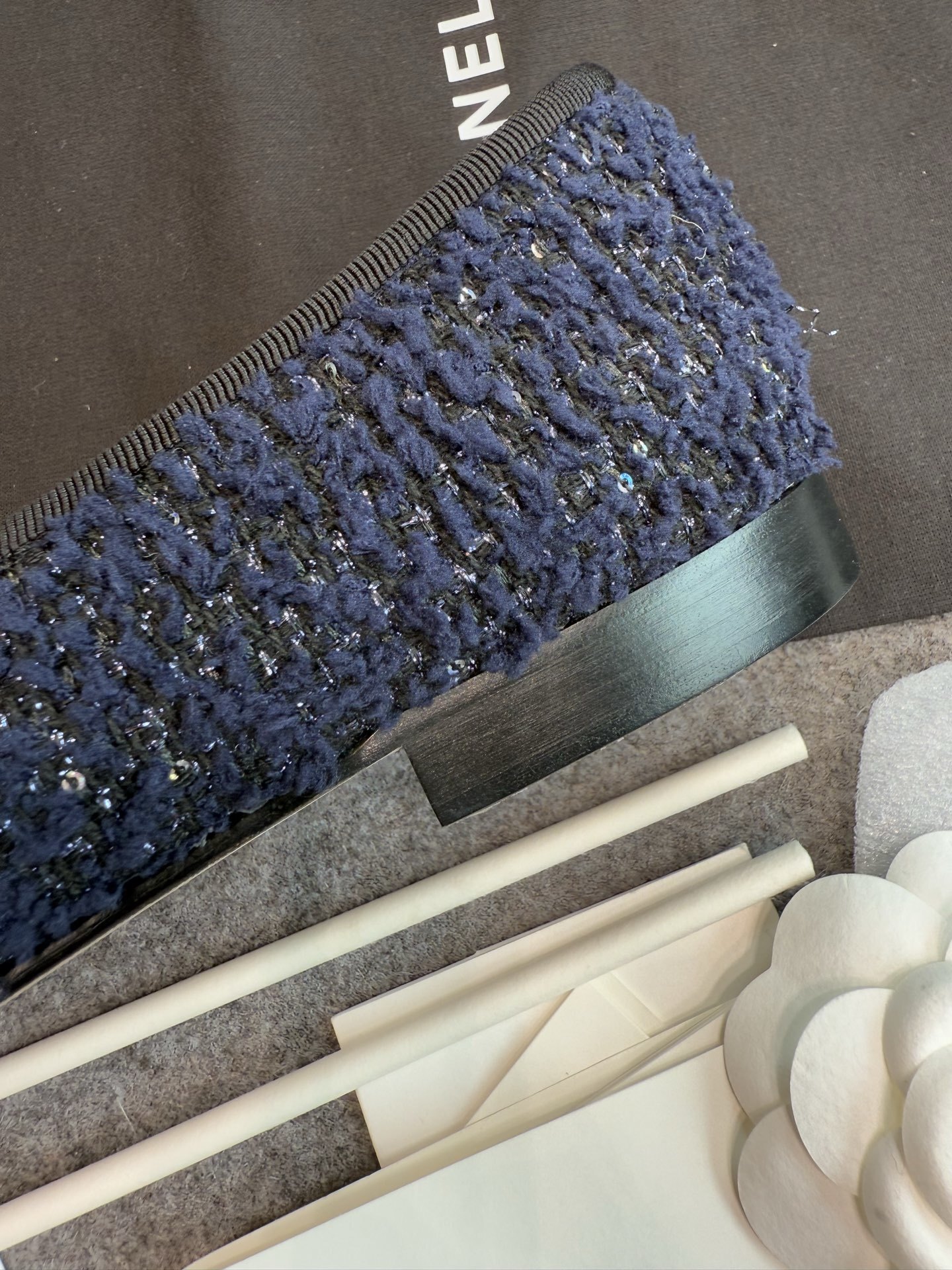 A pair of Chanel dark blue tweed ballet flats with black leather toe caps and CC logo, shown with original box and packaging. - Hình 9