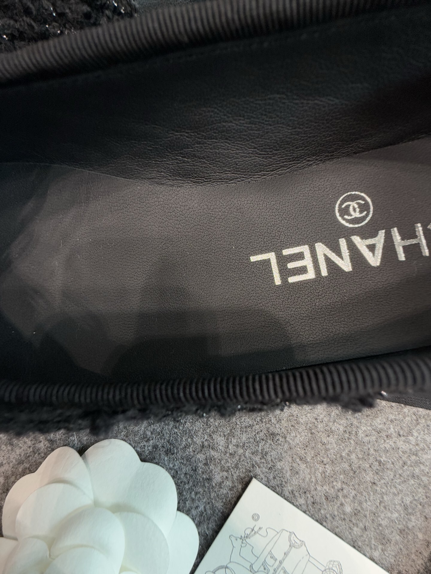 A pair of black Chanel tweed ballerina flats with leather CC logo toe caps and bow details inside a luxury box. - Hình 7