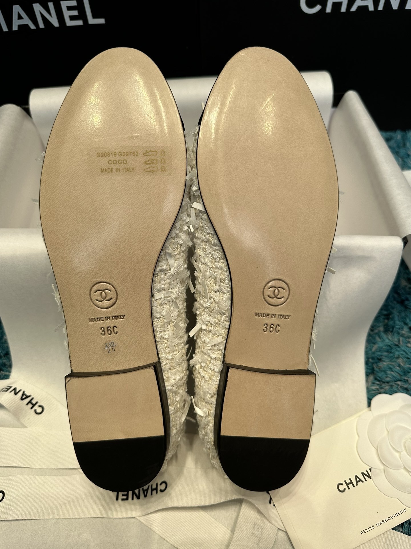 A pair of Chanel white tweed ballet flats with black toe caps and white bows, presented in a Chanel box with branded ribbons. - Hình 5