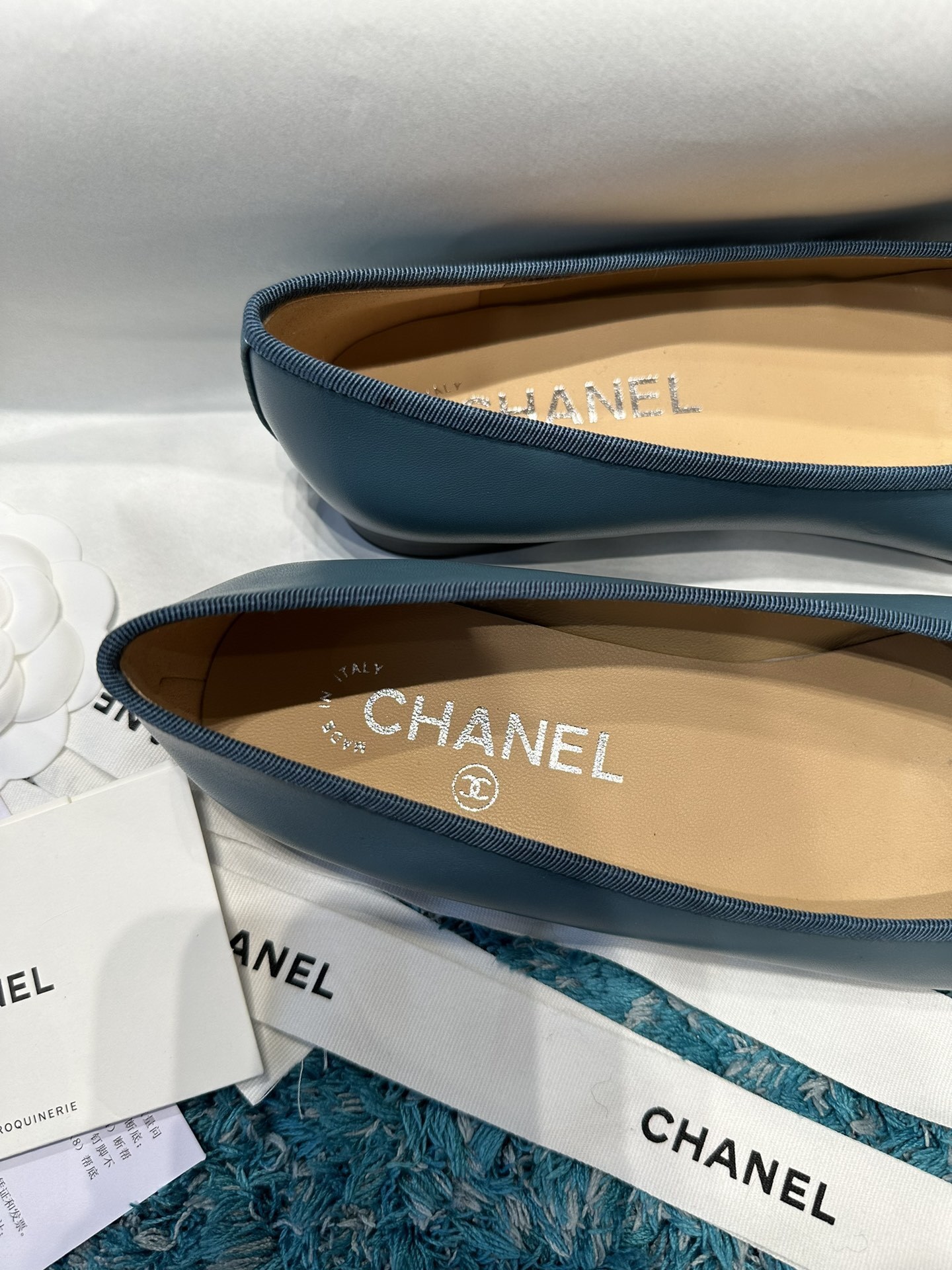 Pair of blue Chanel ballet flats with black toe caps and bow details in original packaging - Hình 9