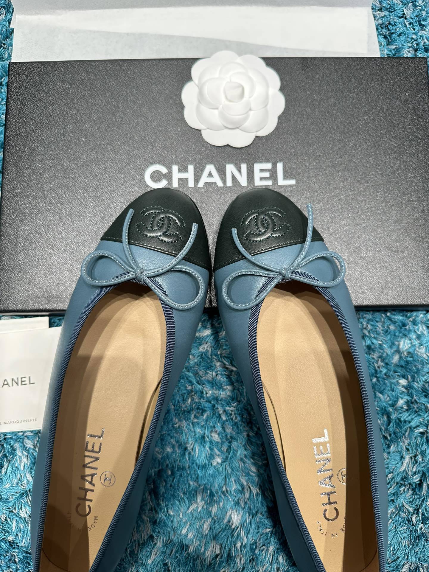 Pair of blue Chanel ballet flats with black toe caps and bow details in original packaging - Hình 6