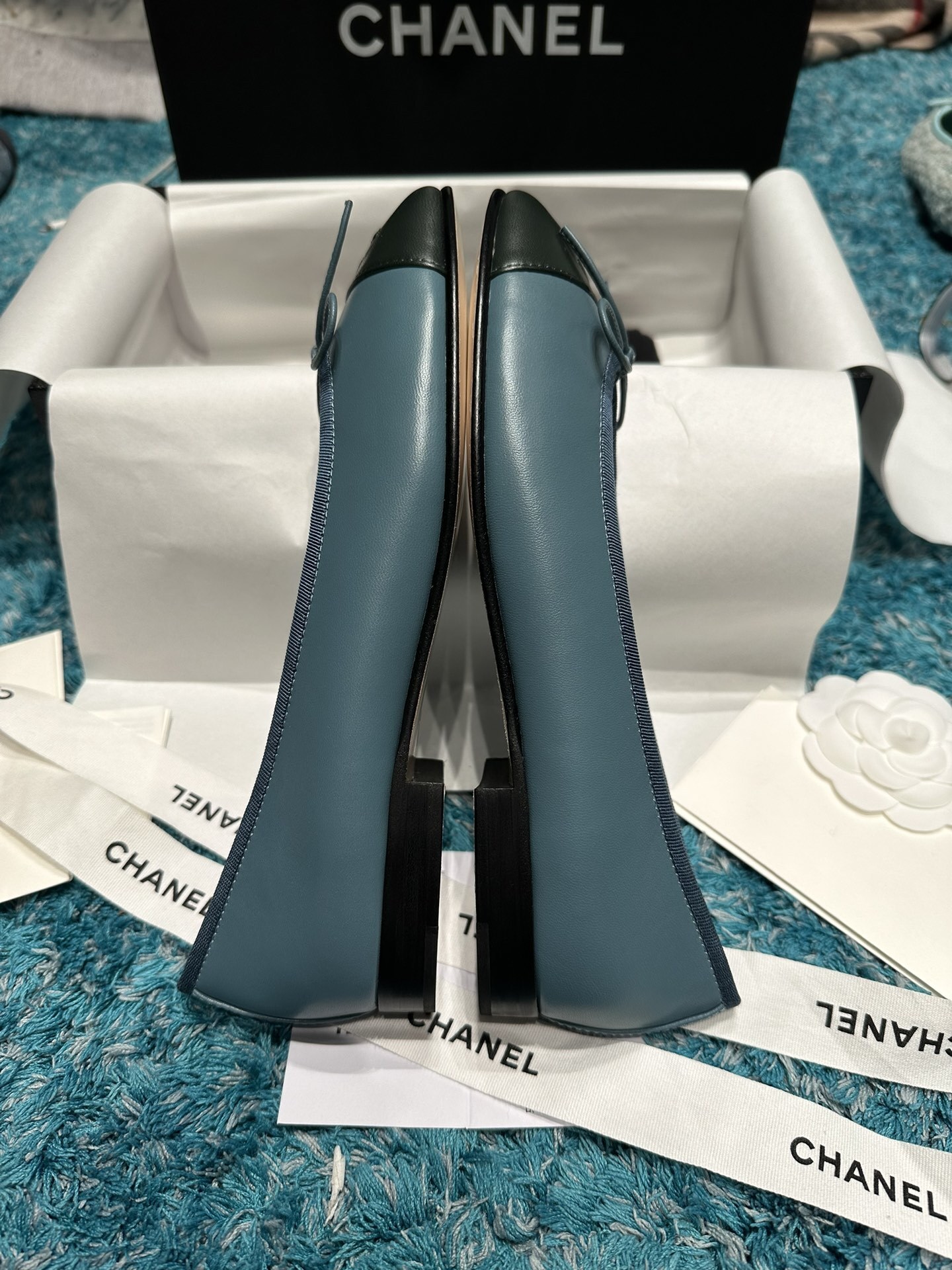 Pair of blue Chanel ballet flats with black toe caps and bow details in original packaging - Hình 5
