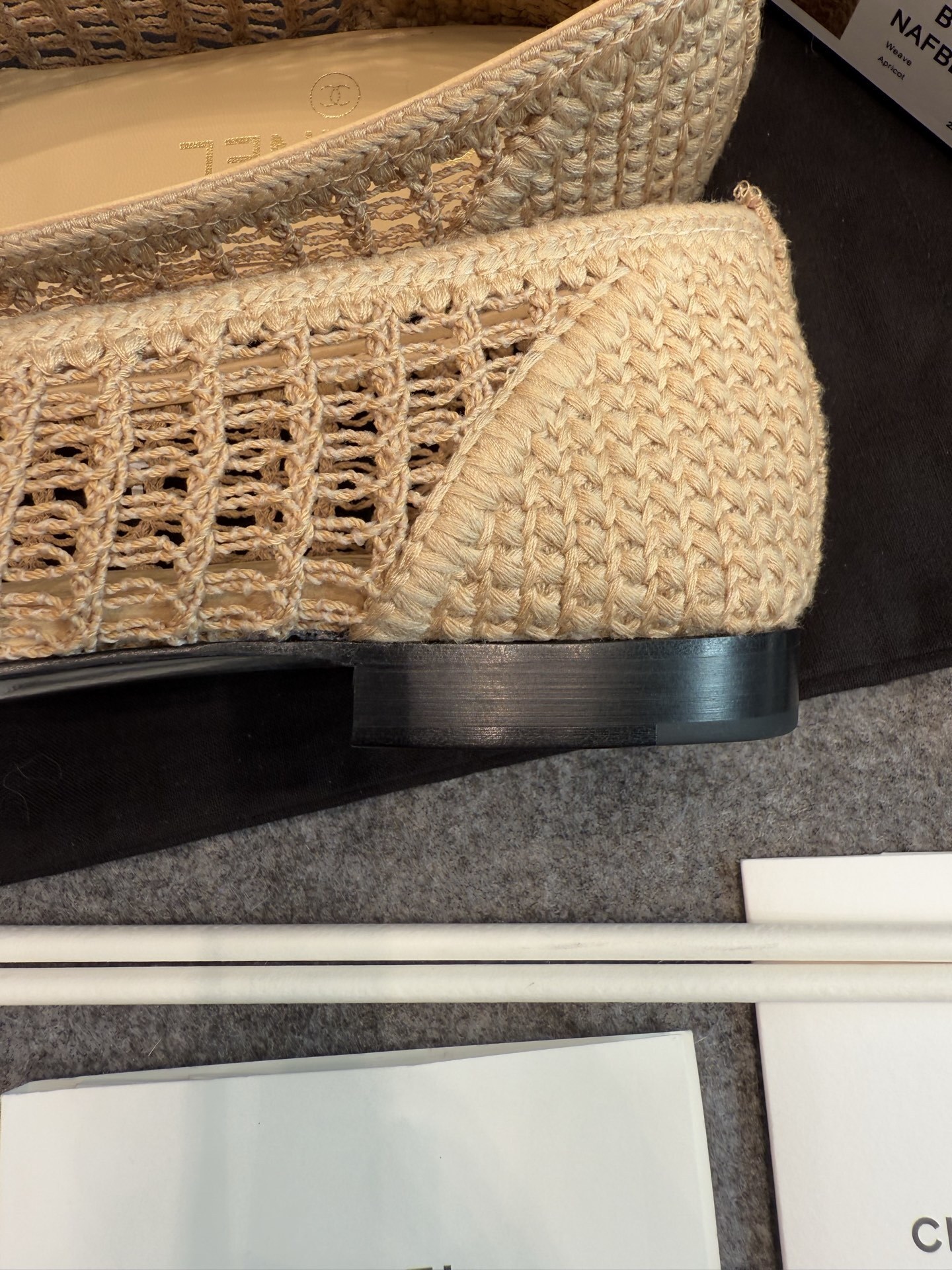 Top view of Chanel beige raffia mesh ballet flats with CC logo on the toe in a luxury box - Hình 8