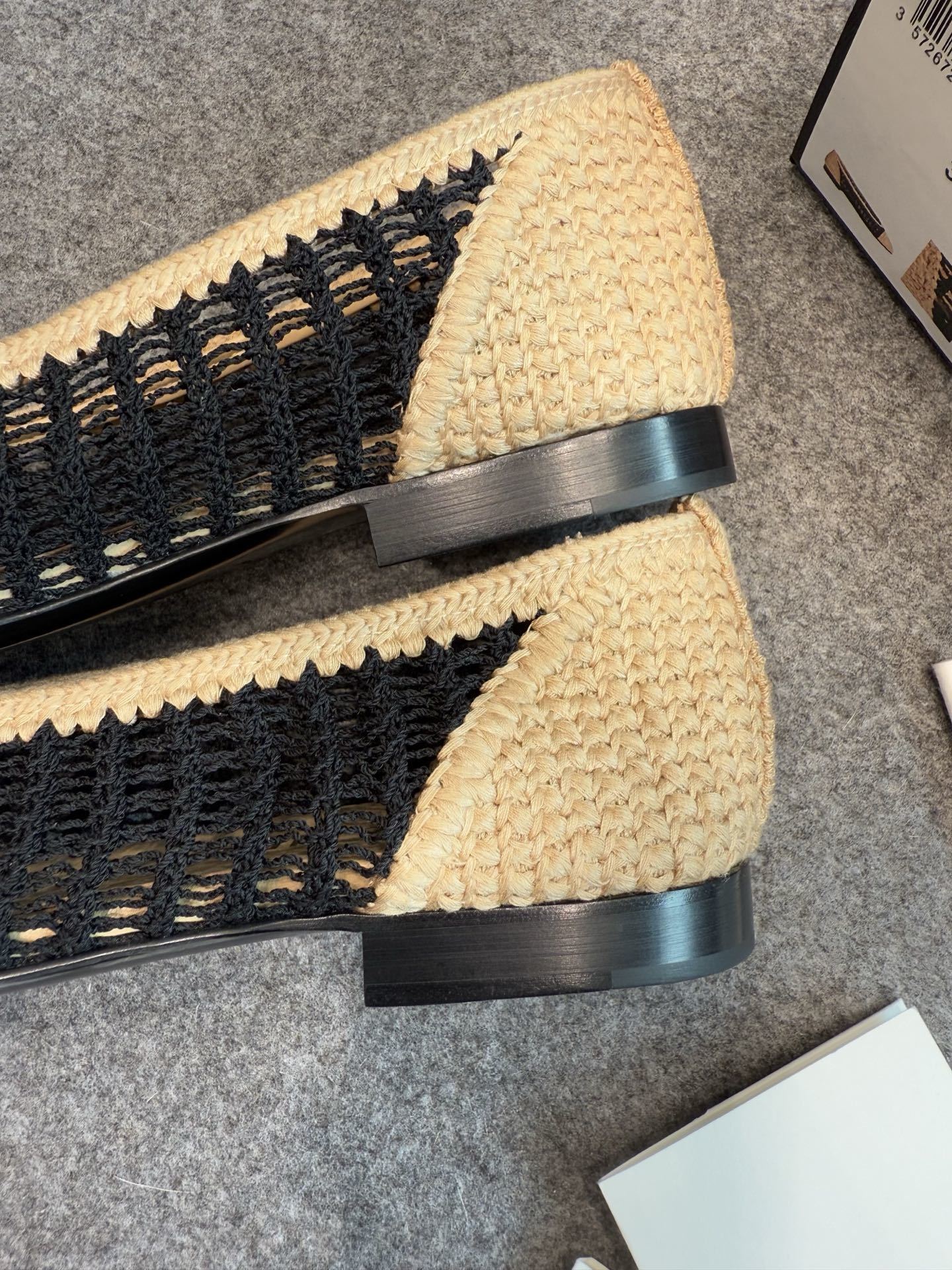 A pair of authentic Chanel beige and black crochet ballet flats with CC logo on the toe, shown with original packaging and camellia flower. - Hình 5