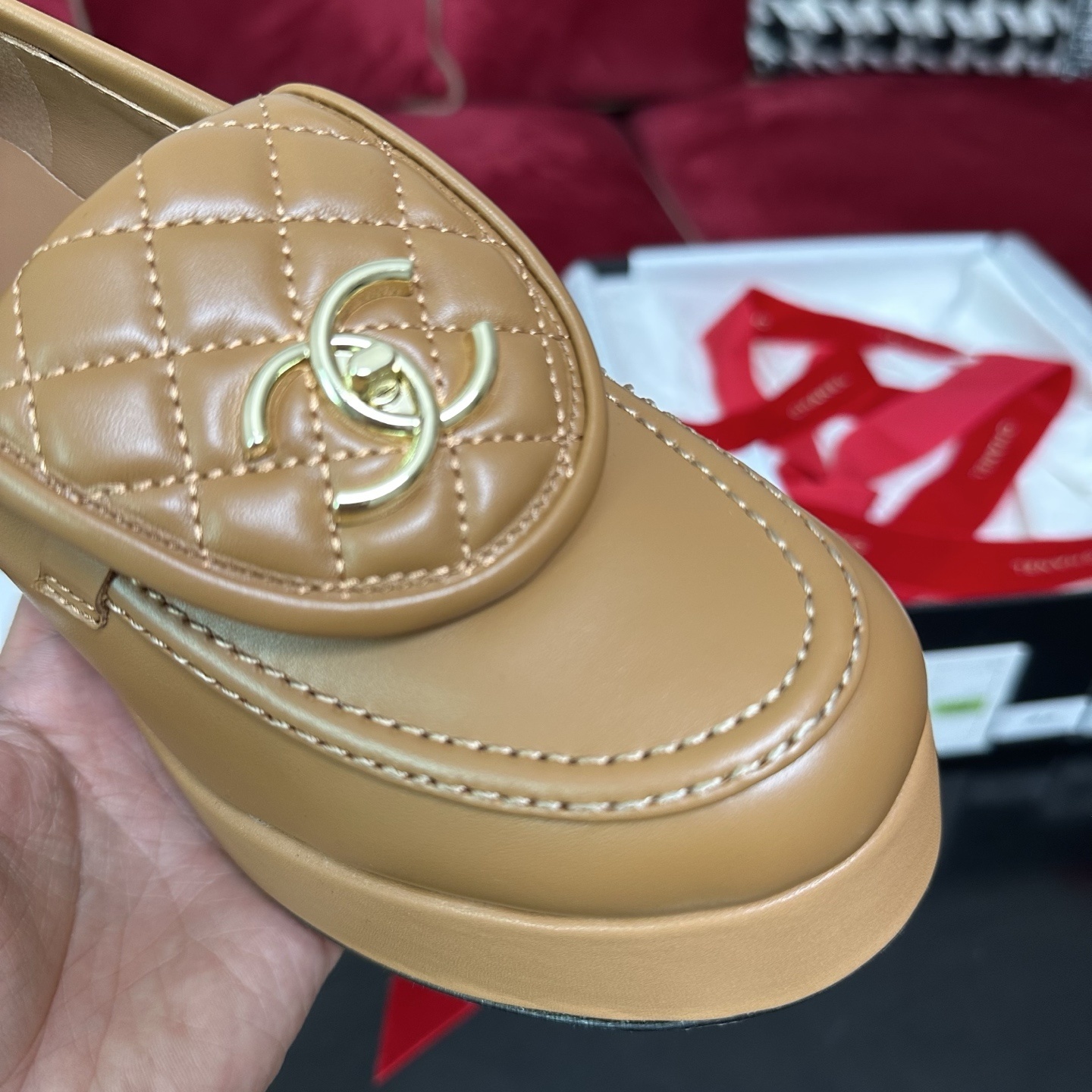 Luxury Chanel tan leather platform loafers with quilted tongue and gold CC logo displayed on a black box. - Hình 6