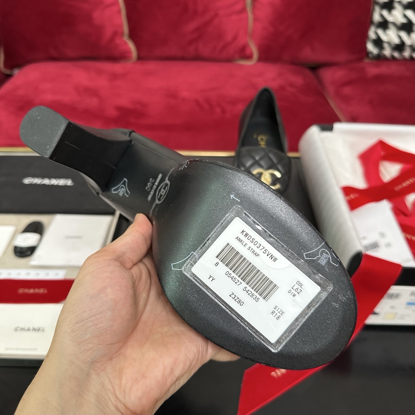 Chanel black quilted leather platform loafers with gold CC logo hardware on a display table with original packaging. - Hình 9