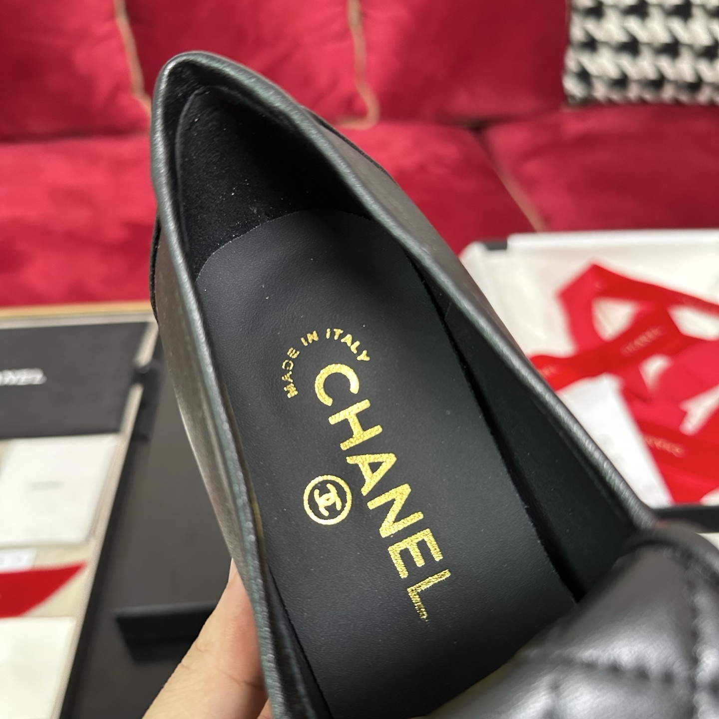 Chanel black quilted leather platform loafers with gold CC logo hardware on a display table with original packaging. - Hình 7