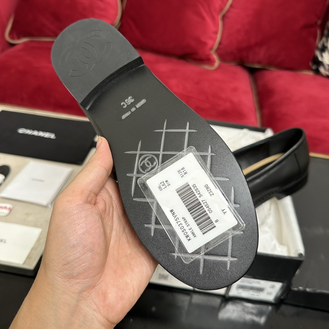 A pair of luxury Chanel black leather loafers with gold CC logo detail in original packaging. - Hình 9