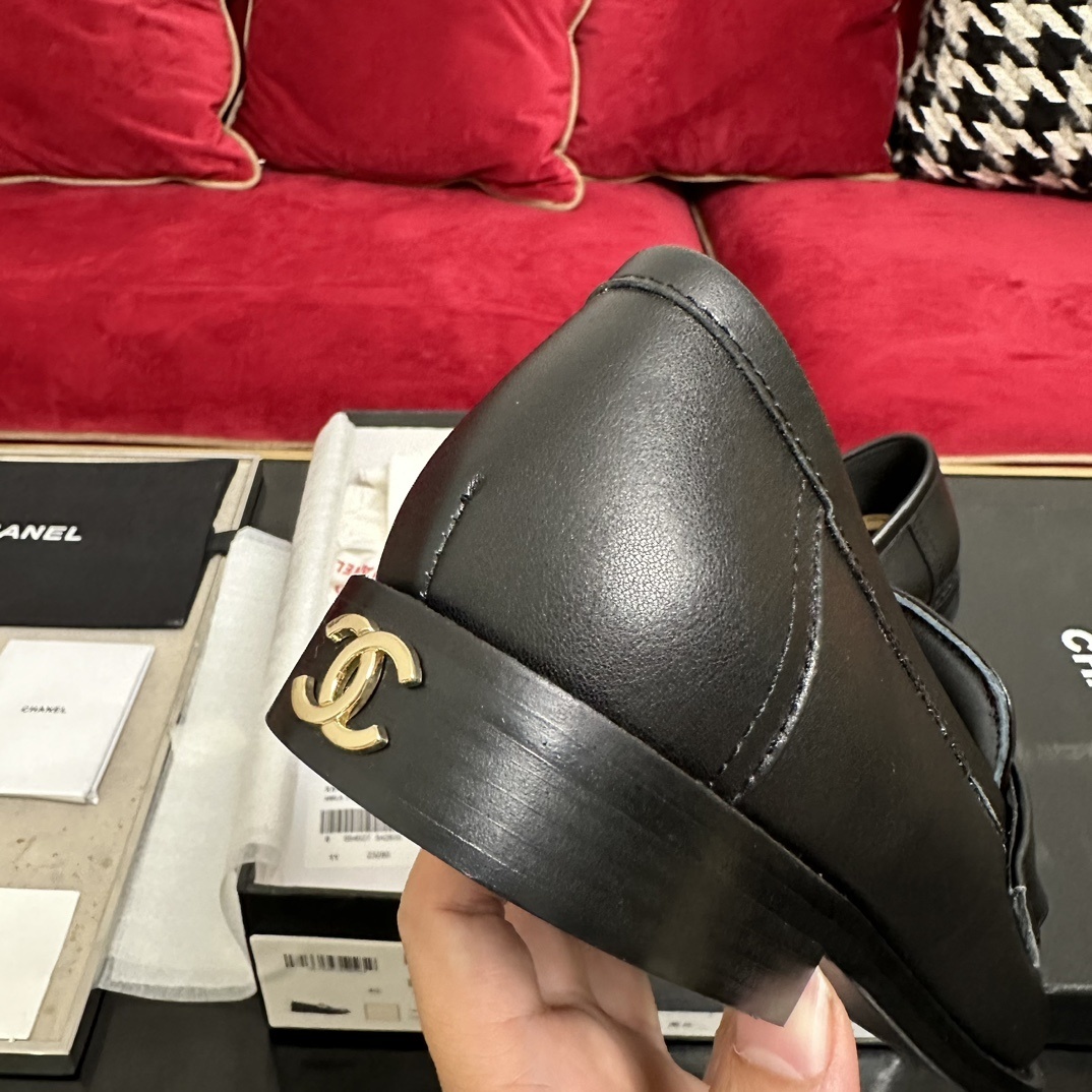A pair of luxury Chanel black leather loafers with gold CC logo detail in original packaging. - Hình 8