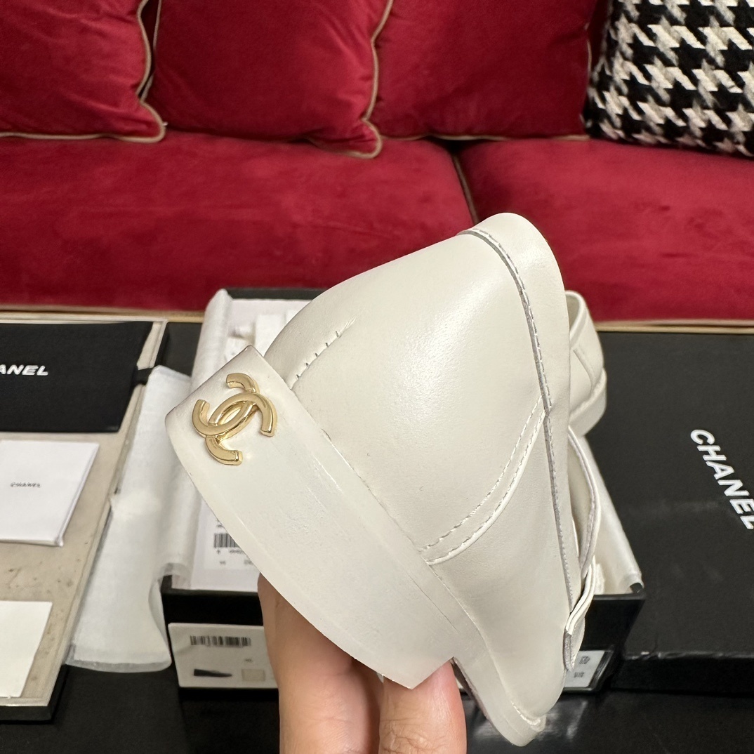 A pair of luxury Chanel white leather loafers with gold CC logo hardware displayed in their original black and white box with authenticity cards. - Hình 8