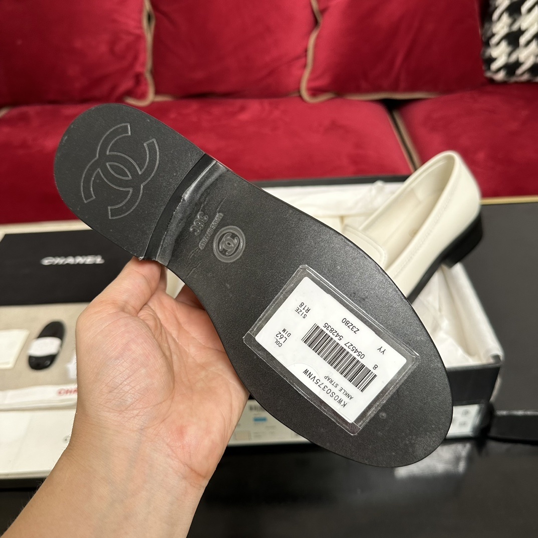 Luxury Chanel white leather loafers with gold CC logo hardware placed in their original black box with accessories - Hình 9
