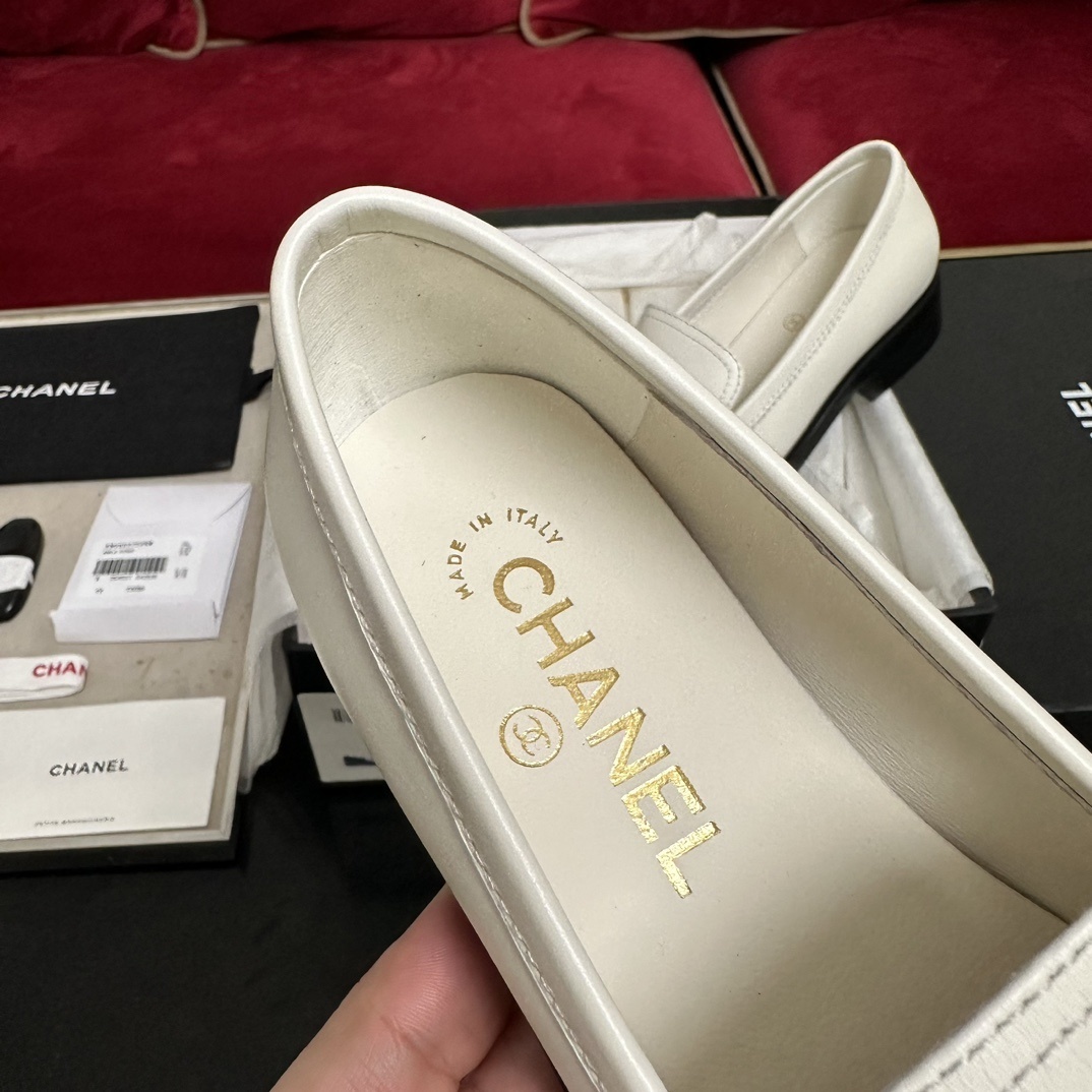 Luxury Chanel white leather loafers with gold CC logo hardware placed in their original black box with accessories - Hình 7
