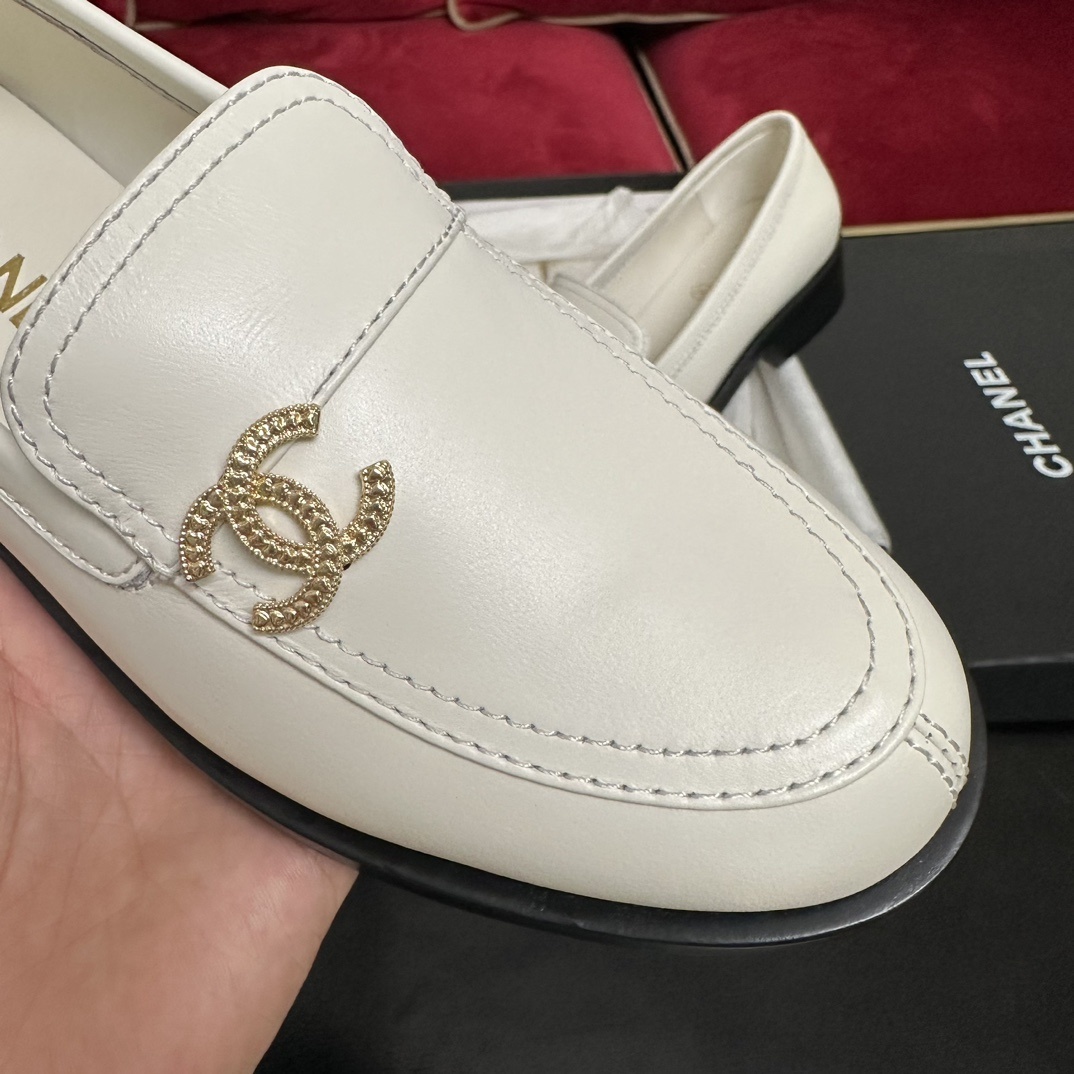 Luxury Chanel white leather loafers with gold CC logo hardware placed in their original black box with accessories - Hình 6