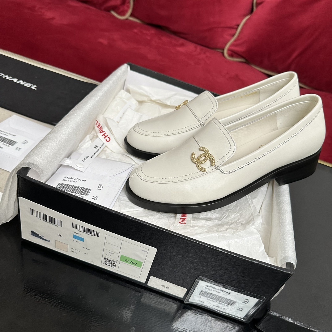Luxury Chanel white leather loafers with gold CC logo hardware placed in their original black box with accessories - Hình 2
