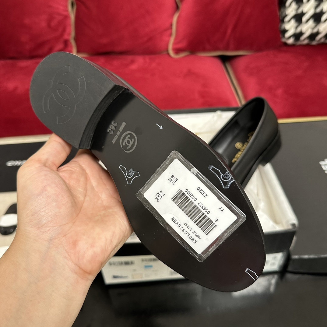 A pair of black leather Chanel loafers with a gold CC logo presented in their original box with a dust bag and cards. - Hình 9