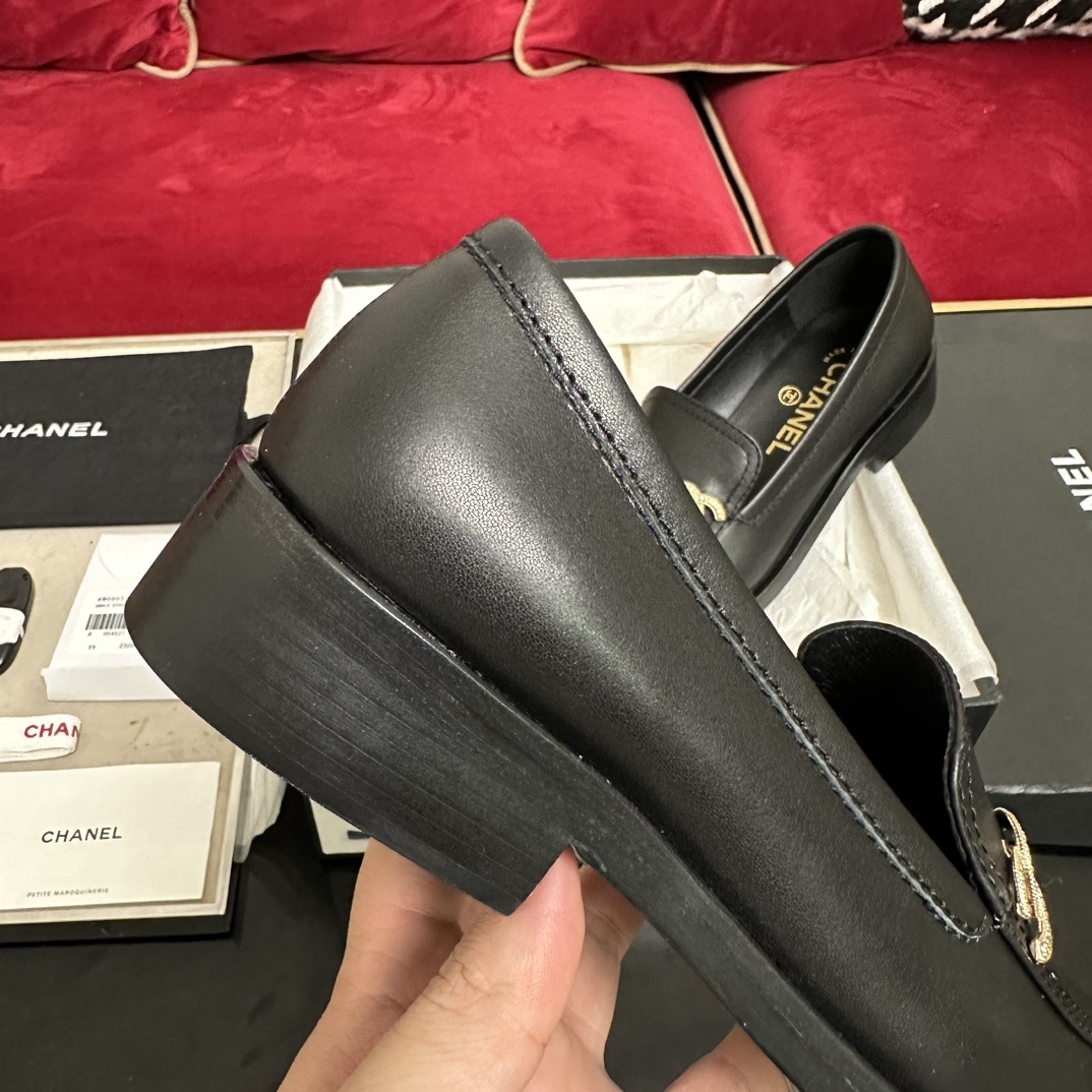 A pair of black leather Chanel loafers with a gold CC logo presented in their original box with a dust bag and cards. - Hình 8