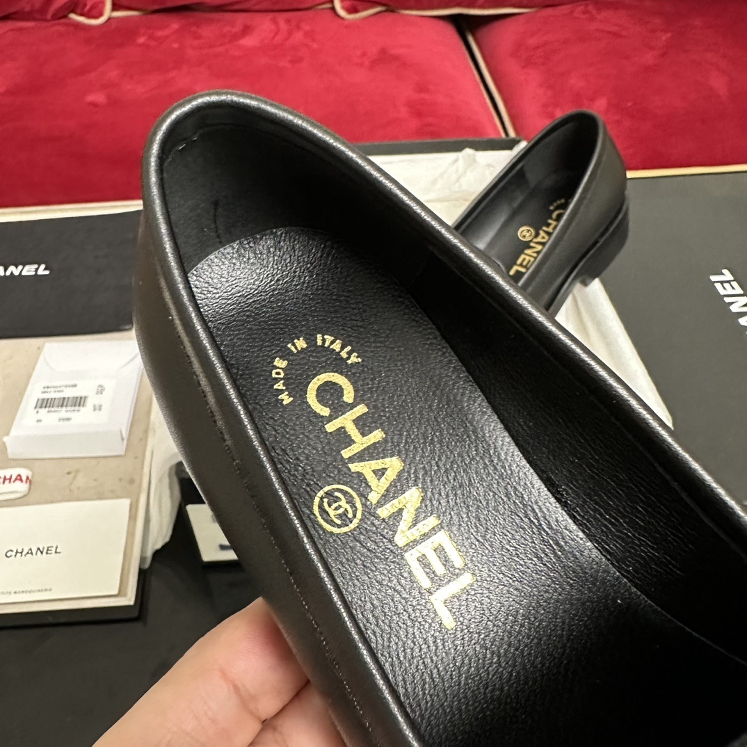 A pair of black leather Chanel loafers with a gold CC logo presented in their original box with a dust bag and cards. - Hình 7