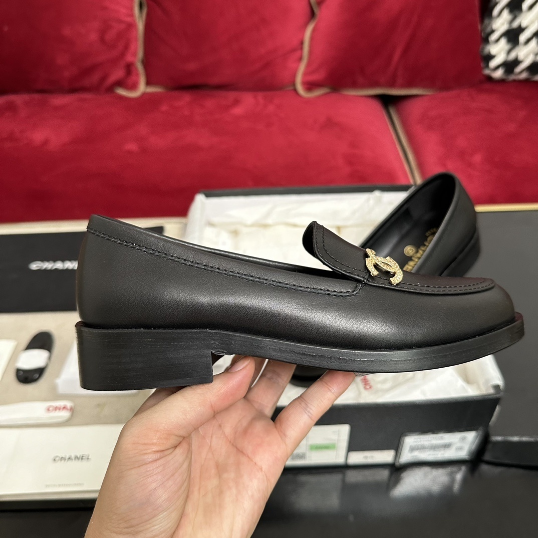 A pair of black leather Chanel loafers with a gold CC logo presented in their original box with a dust bag and cards. - Hình 5