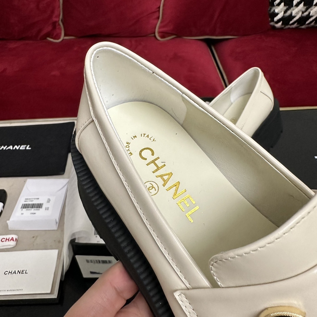 Luxury Chanel cream leather loafers with chunky black platform soles and gold metal logo lettering on the front strap. - Hình 7