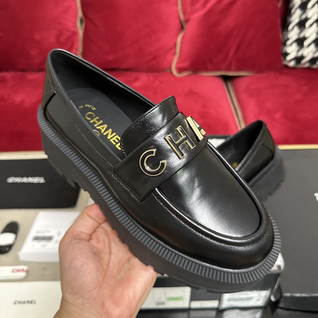 Pair of Chanel black leather platform loafers with gold-tone CHANEL logo lettering on the strap and chunky lug soles. - Hình 4