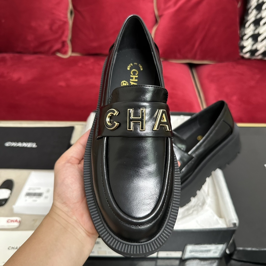 Pair of Chanel black leather platform loafers with gold-tone CHANEL logo lettering on the strap and chunky lug soles. - Hình 3