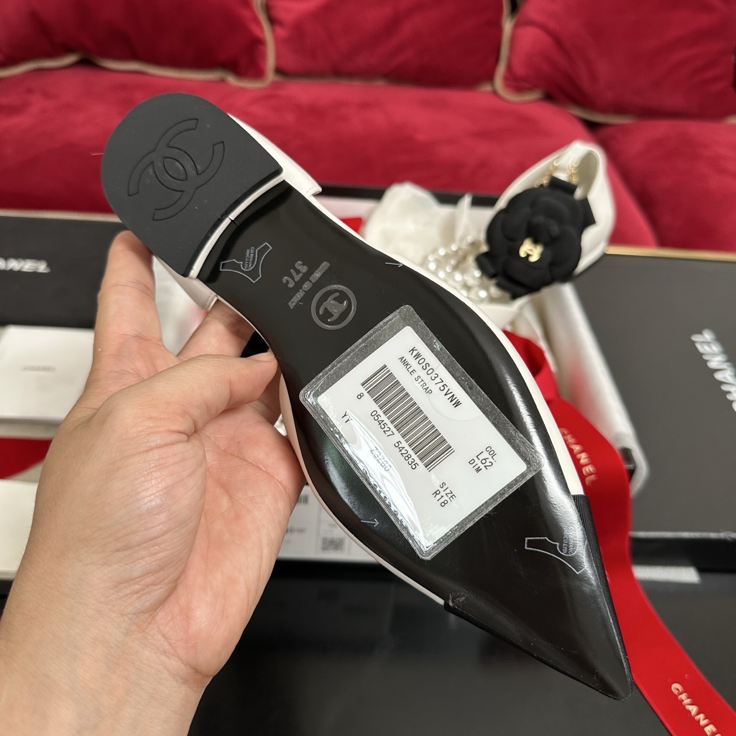 Chanel white leather mules with black cap toe, pearl ankle strap, and black camellia flower charm in original packaging. - Hình 9