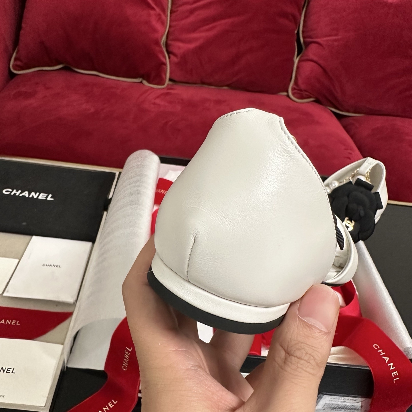 Chanel white leather mules with black cap toe, pearl ankle strap, and black camellia flower charm in original packaging. - Hình 8