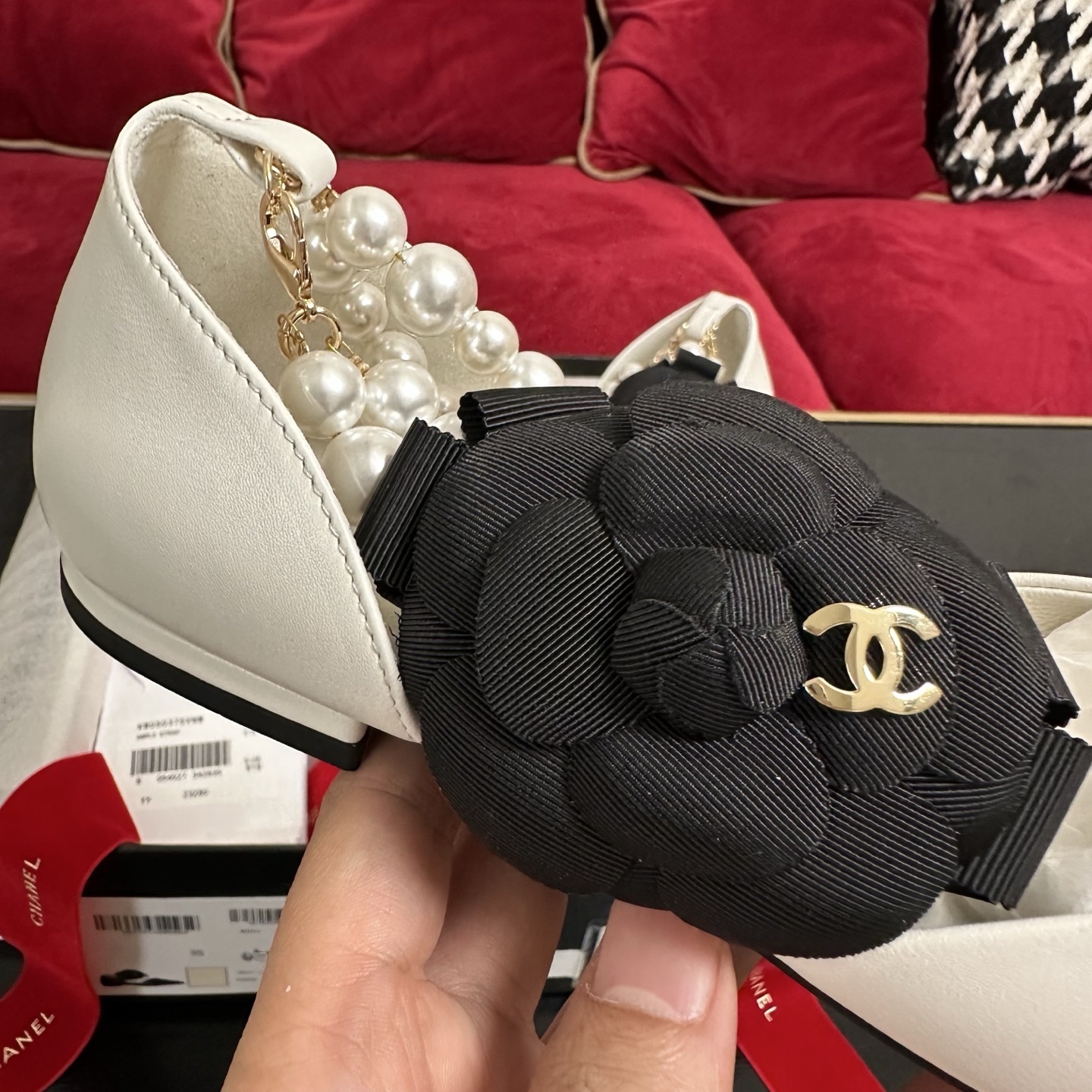 Chanel white leather mules with black cap toe, pearl ankle strap, and black camellia flower charm in original packaging. - Hình 7