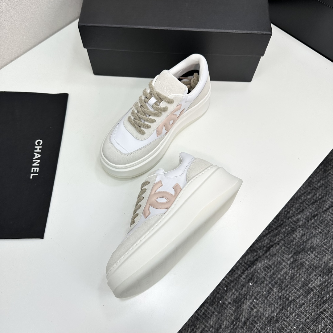 Chanel white and pink platform sneakers displayed on a black box with a branded dust bag - Hình 6